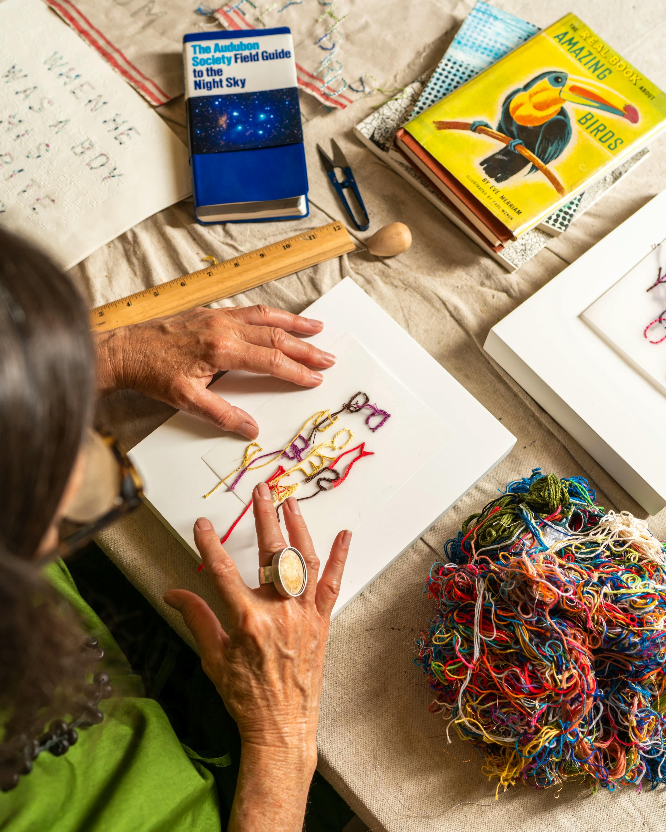 Artist Gail Tarantino threading words on canvas during her residency at MacArthur Place in Sonoma, CA. 