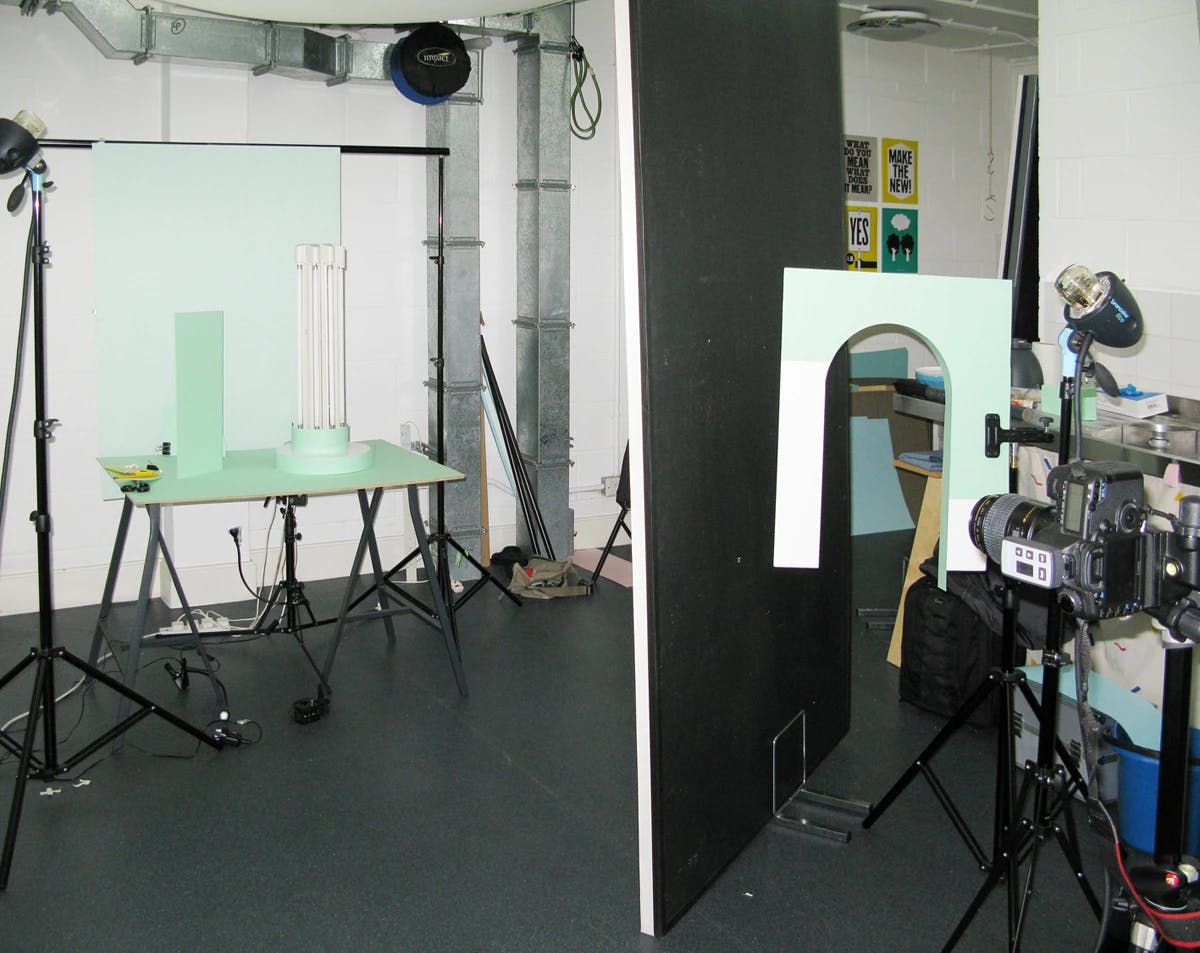 Artist Martina Lang's photography studio with light green backdrops.