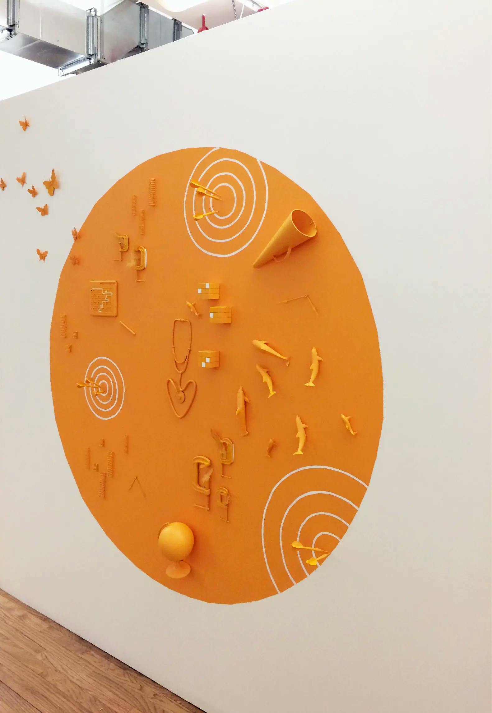 A custom orange wall-installation by artist Christina Watka at One Medical Group.
