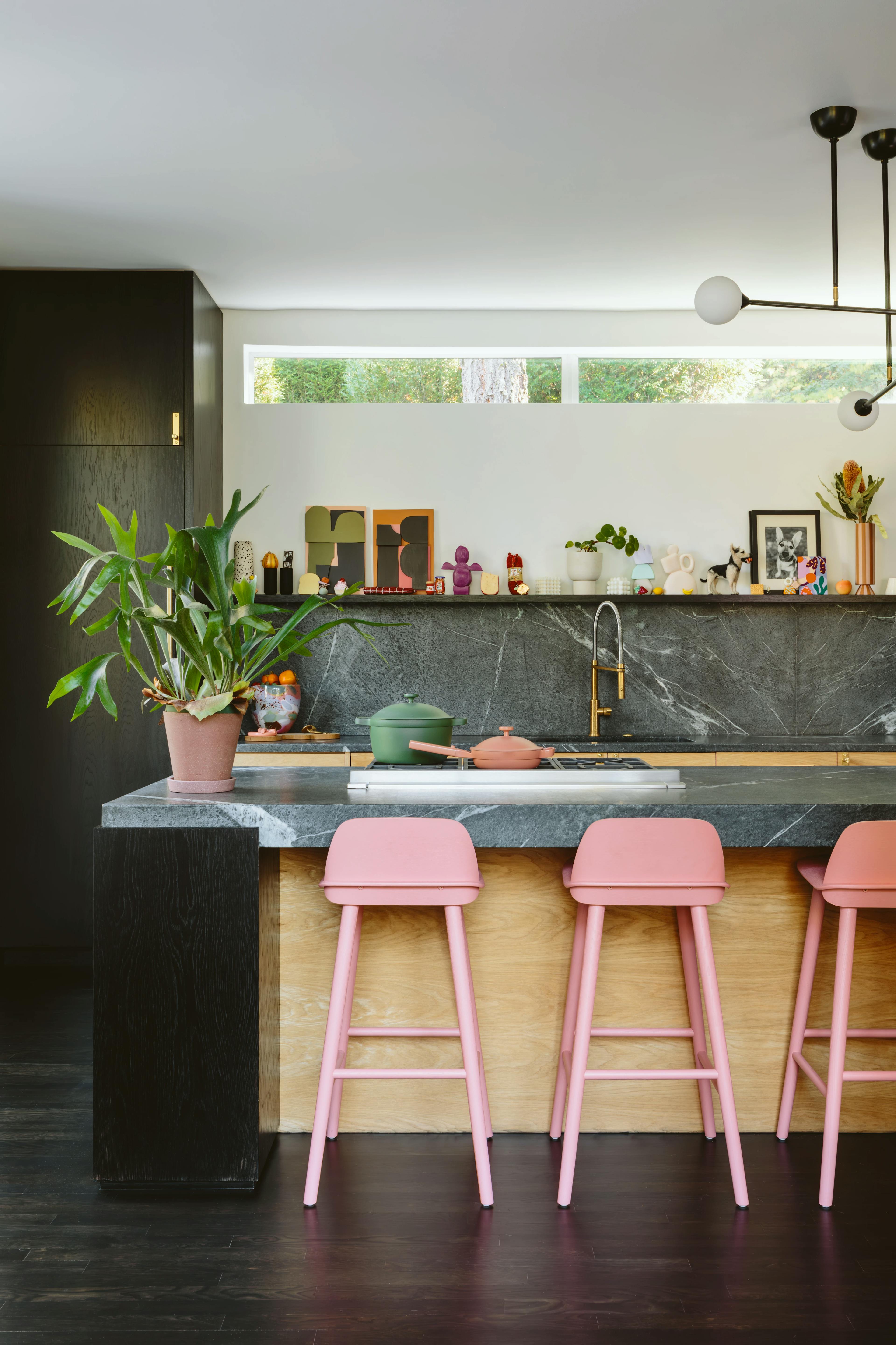 Pink stools at the central island in artist Alex Proba's kitchen. 
