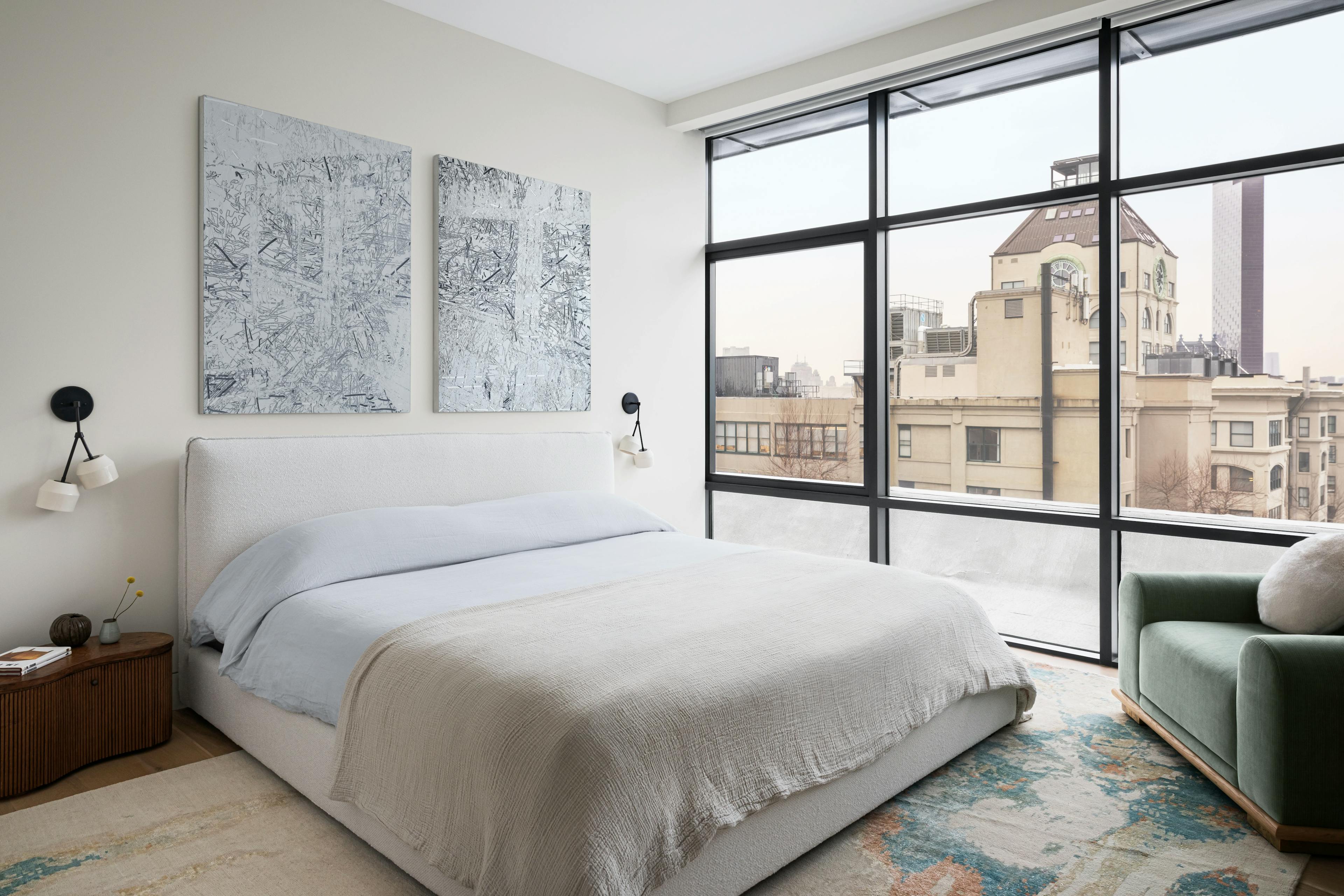 Textured, gray diptych by artist Blake Aaseby installed above a bed in a bedroom with floor-to-ceiling windows.