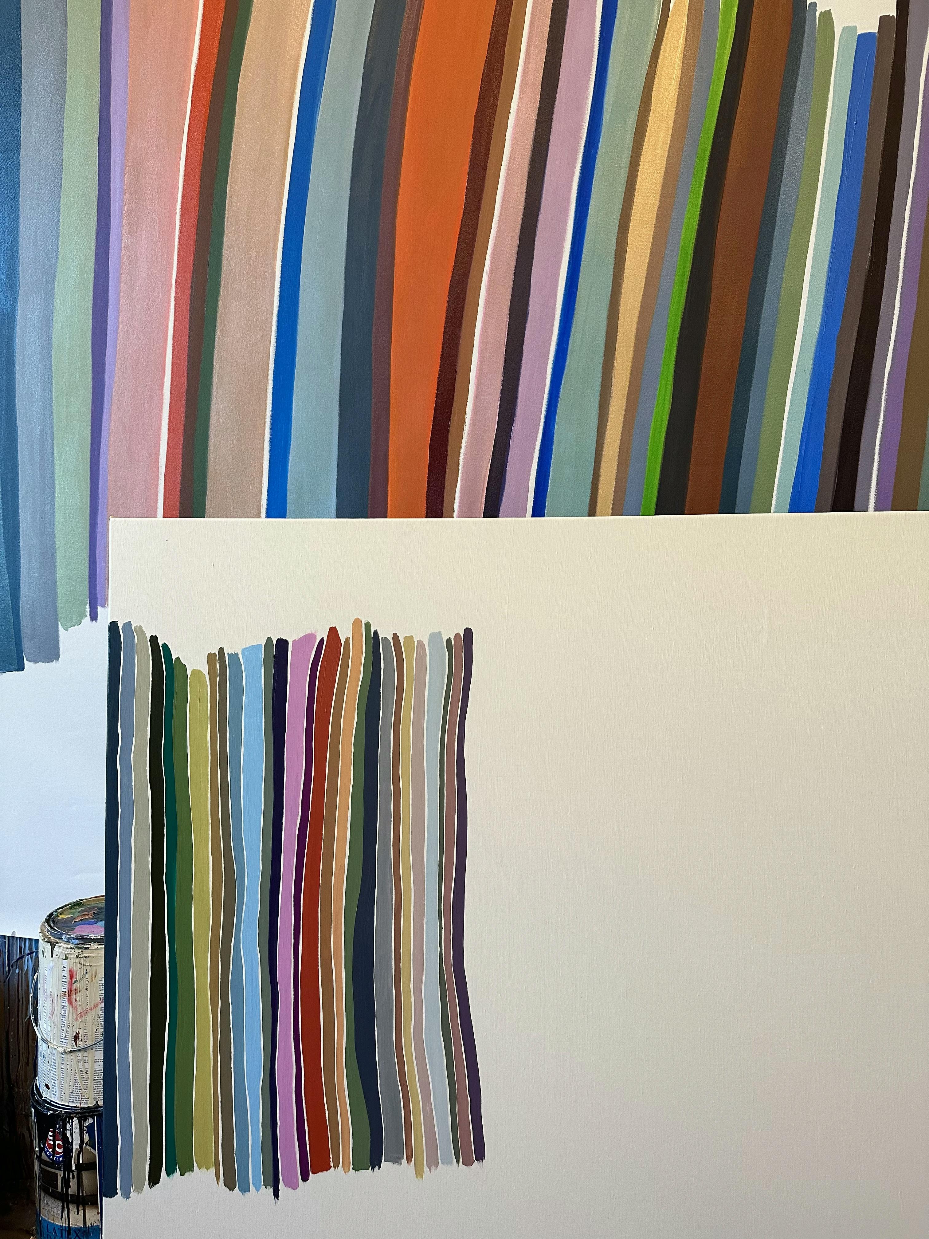 Two in-progress multicolored paintings by John Platt in his studio. 