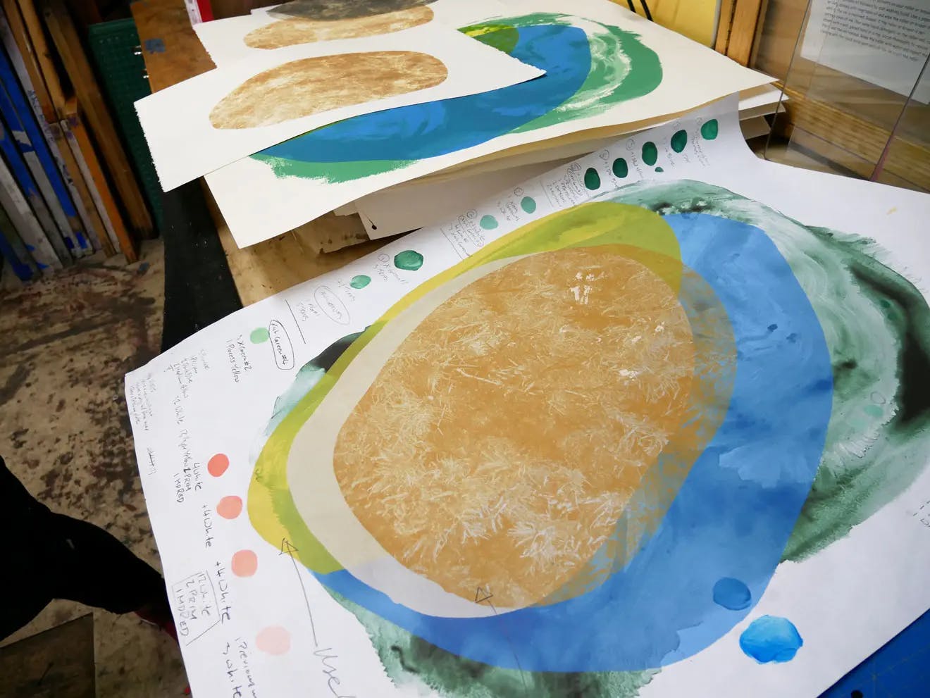 Layered watercolor works in progress by artist Xochi Solis.