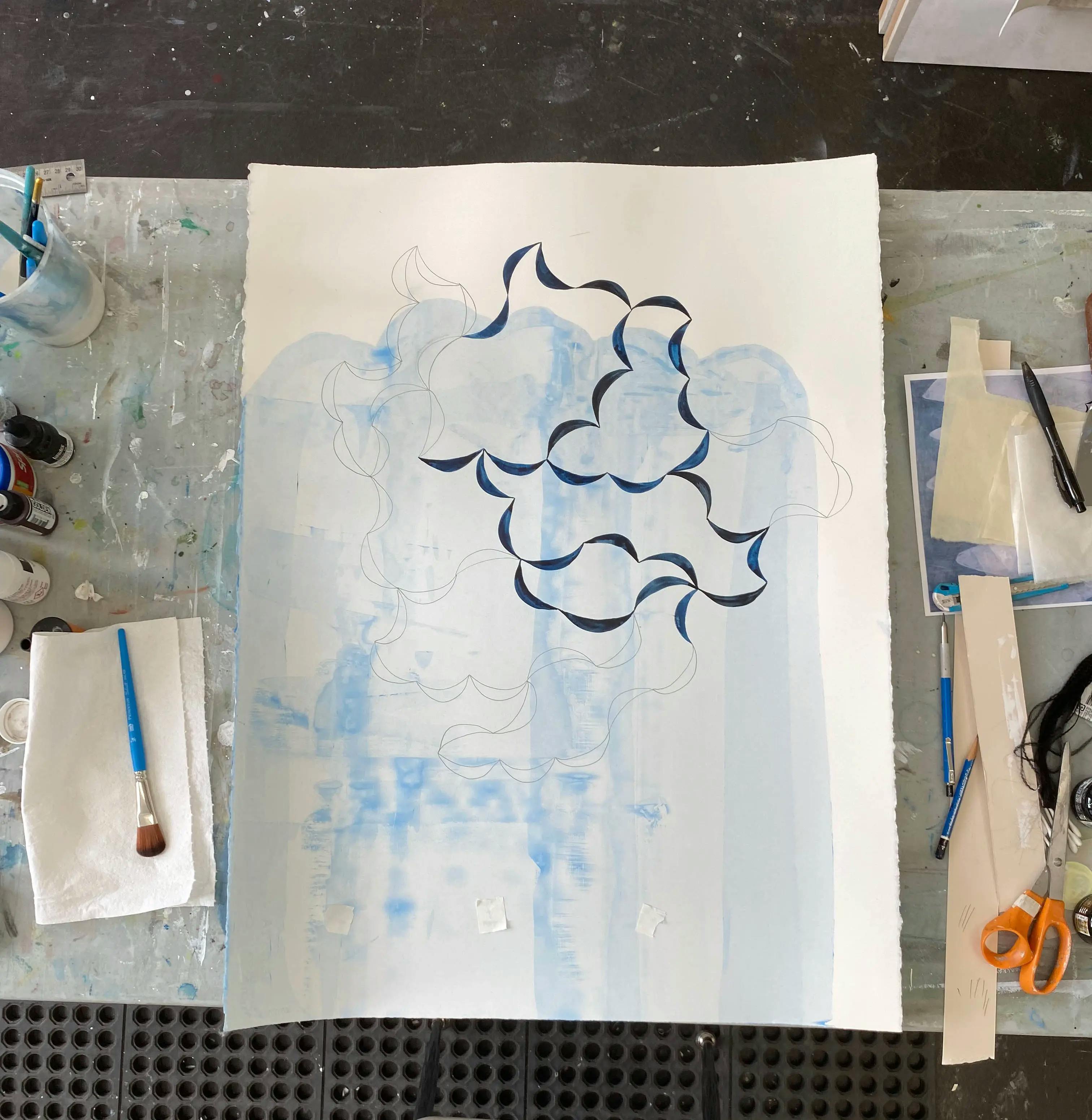A blue, aqueous drawing by artist Lydia Bassis on a surface in her studio.
