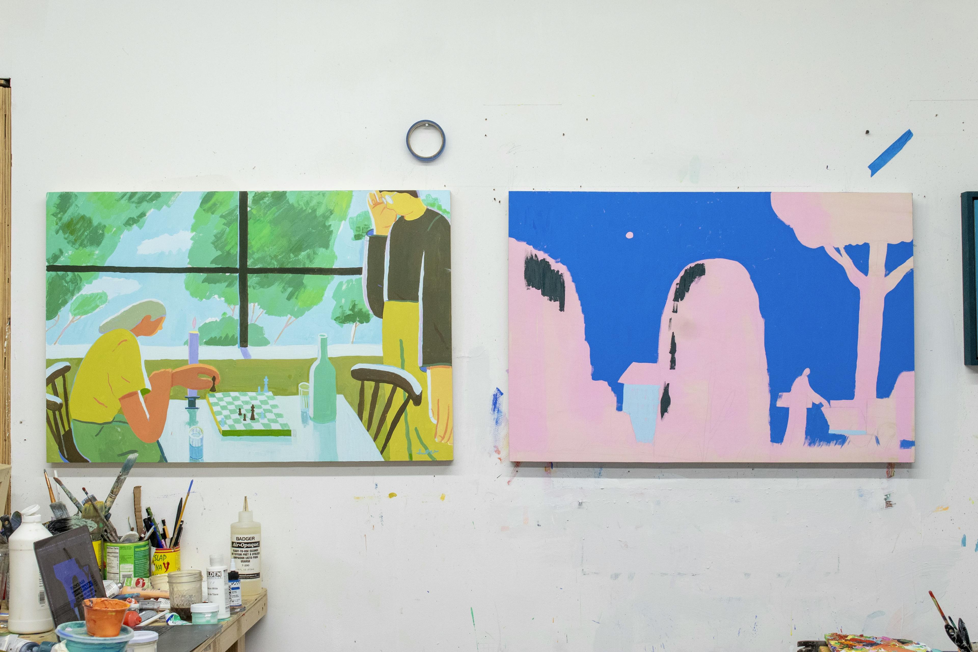 Two colorful paintings on a white wall in artist Jackson Joyce's Brooklyn studio.