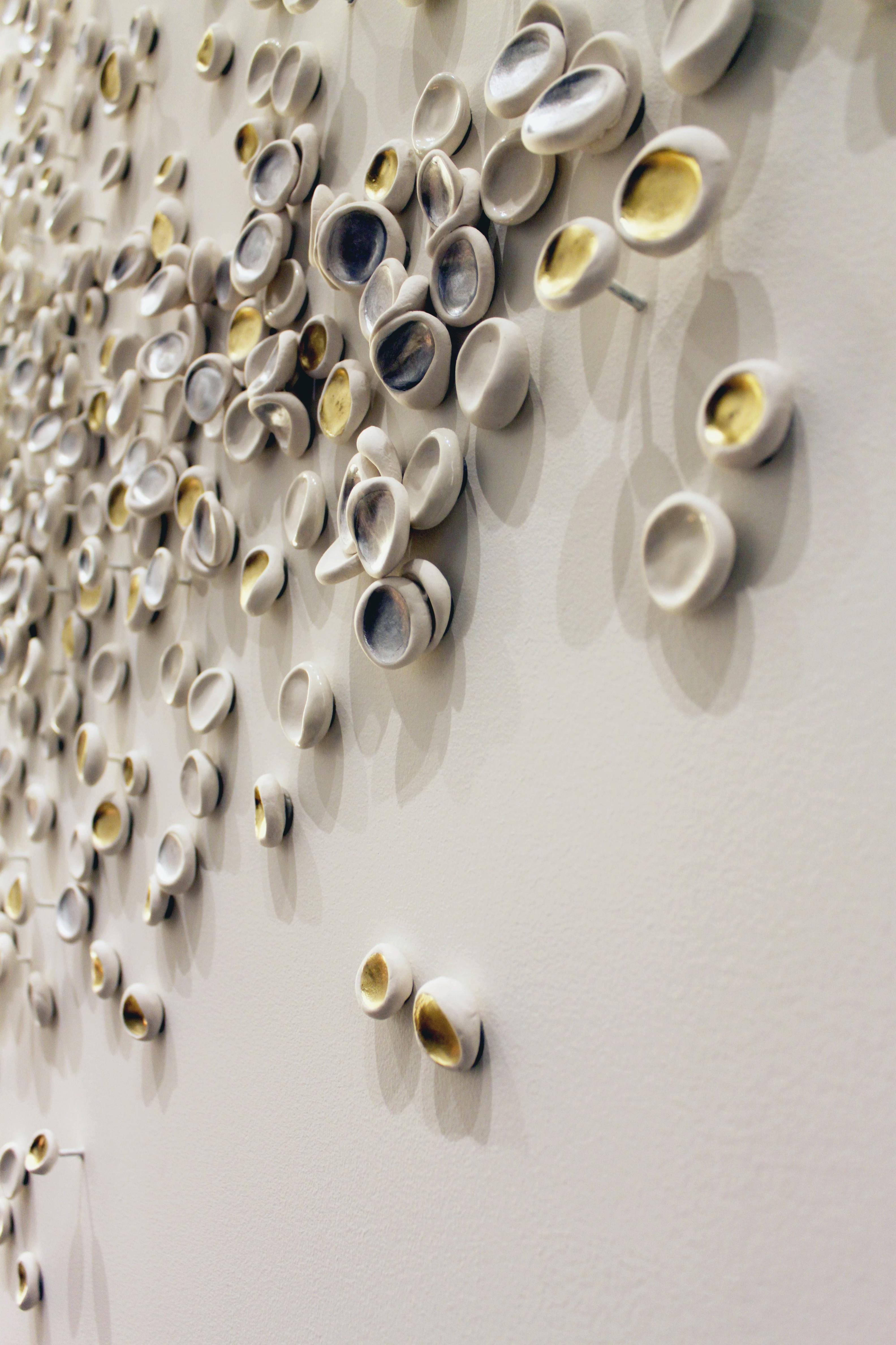 Close-up of small porcelain pieces with gold leaf by artist Christina Watka.