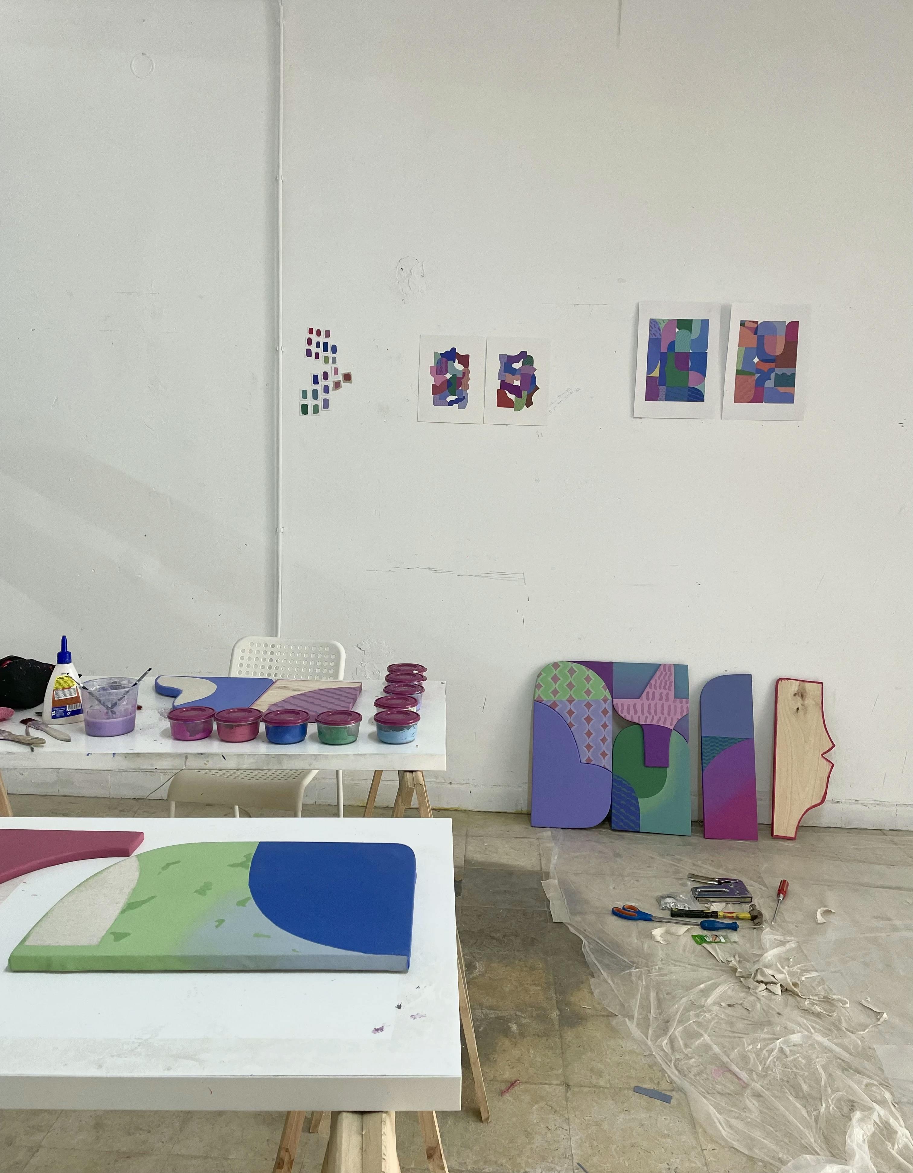 Multicolored drawings and shaped canvases in artist Bbblob's studio.