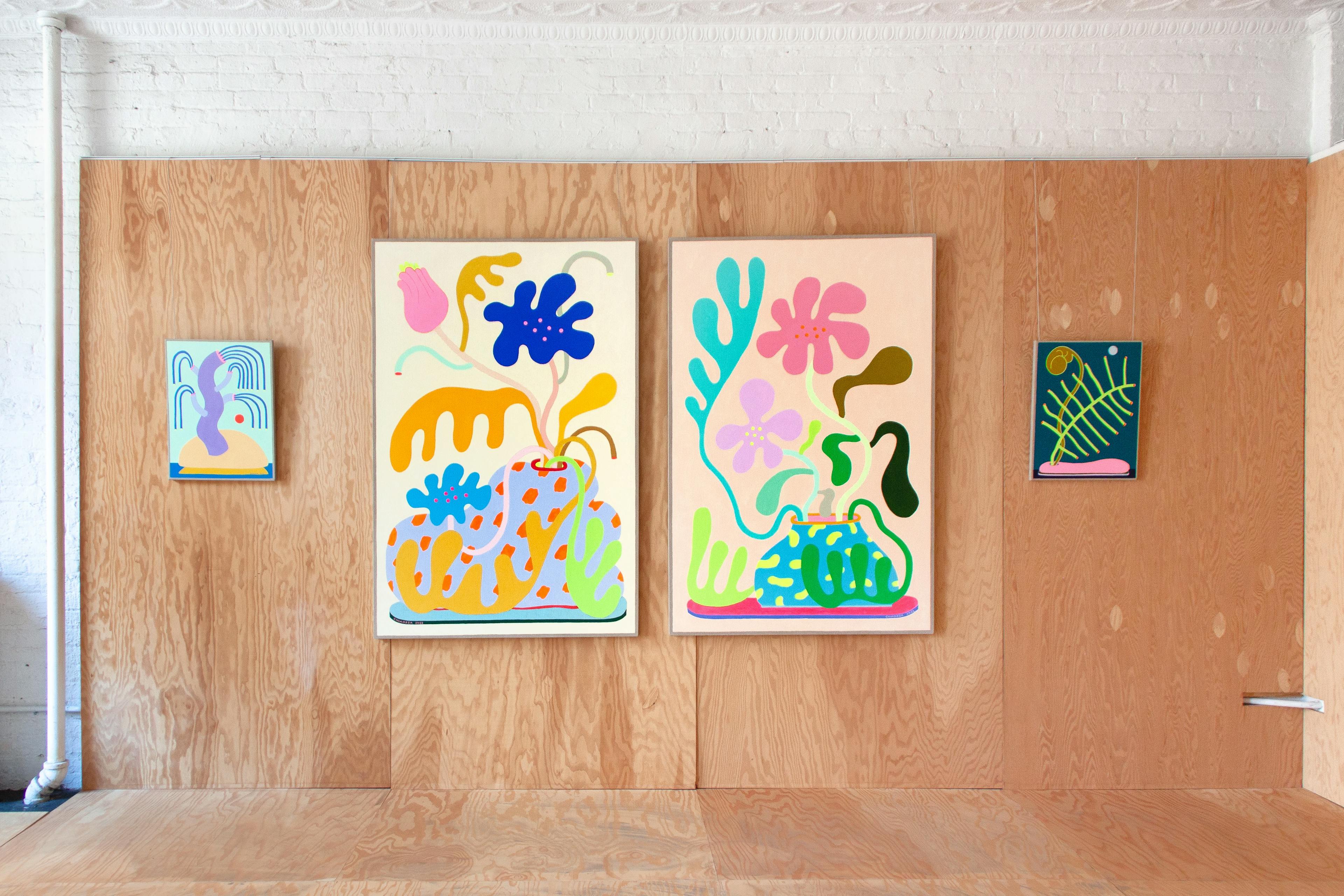 Four abstract floral paintings by CHIAOZZA hanging in a gallery, as part of the exhibition Slow Growth.