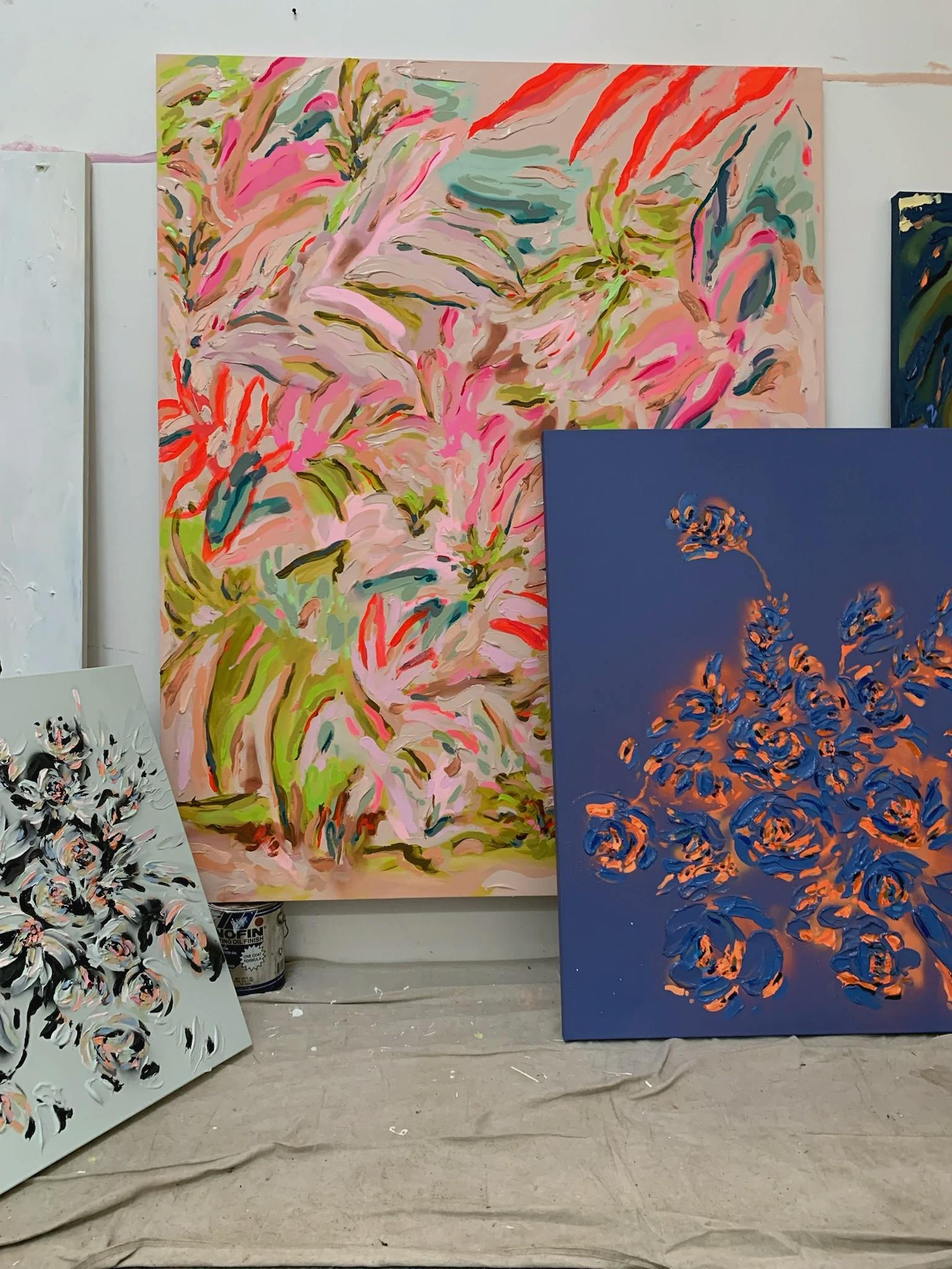Three large floral paintings by Artist Erin Lynn Welsh in her studio. 