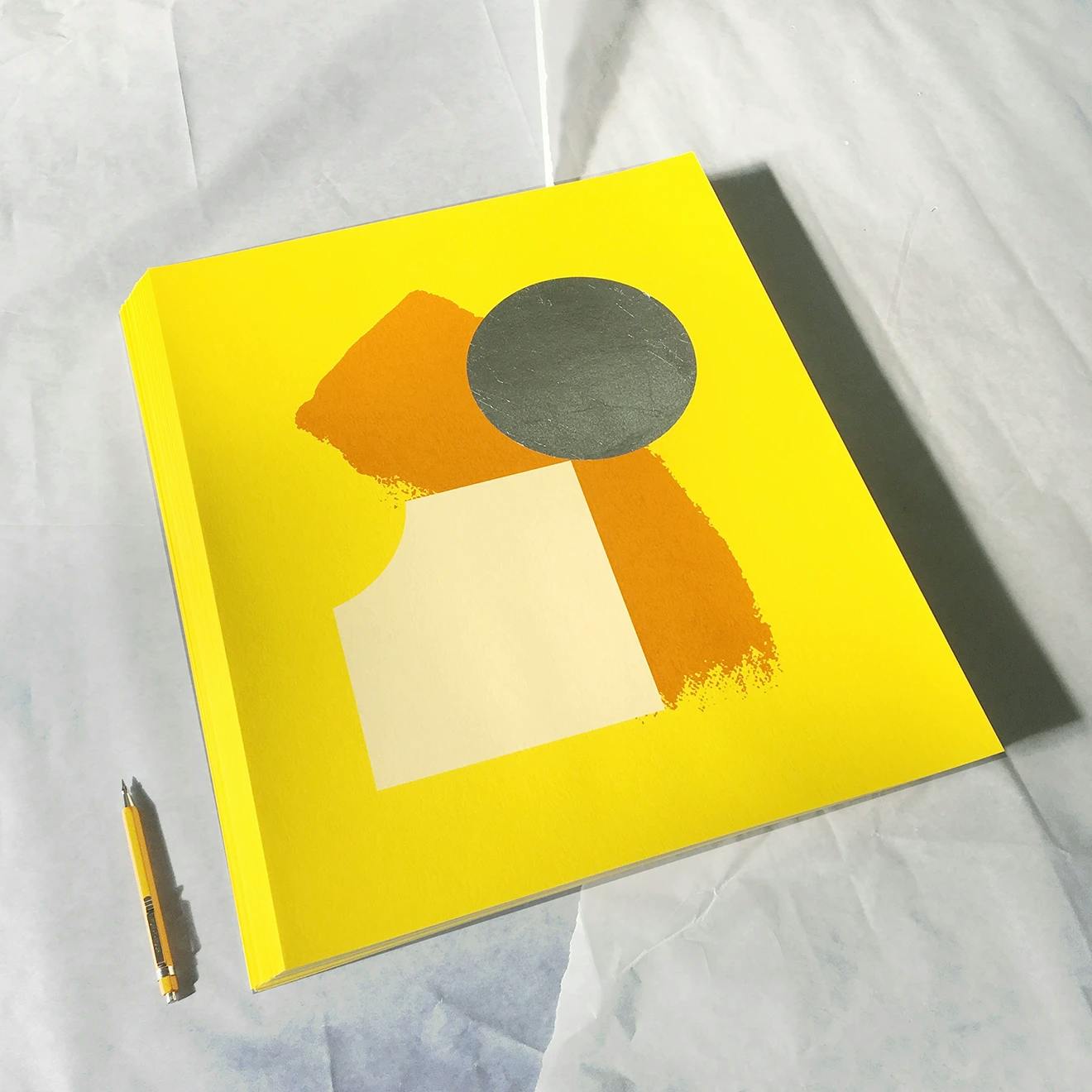 A stack of Chad Kouri's print Opportunity for Reflection (Yellow).