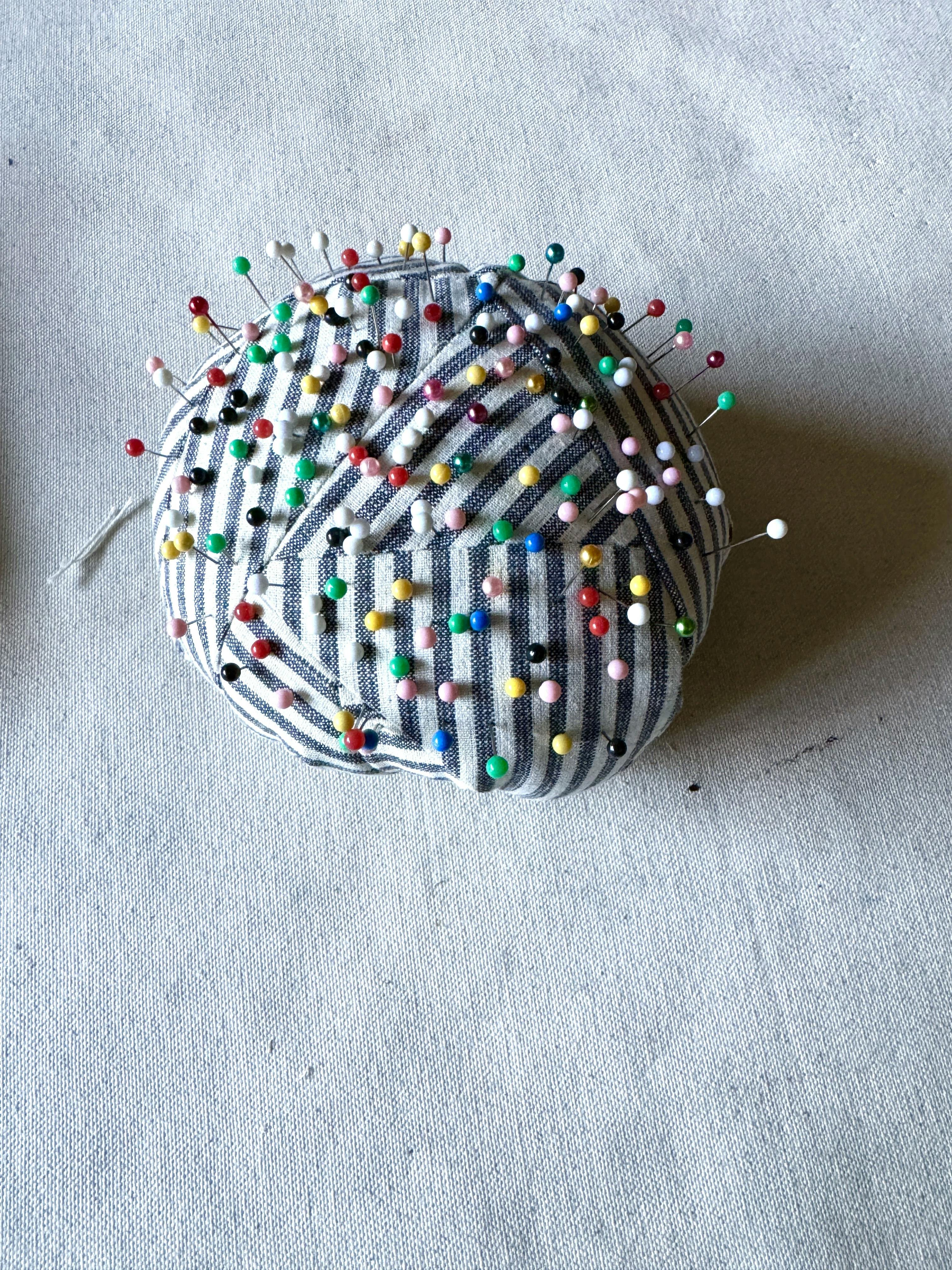 Pins in a pincushion in Carrie Crawford's studio. 