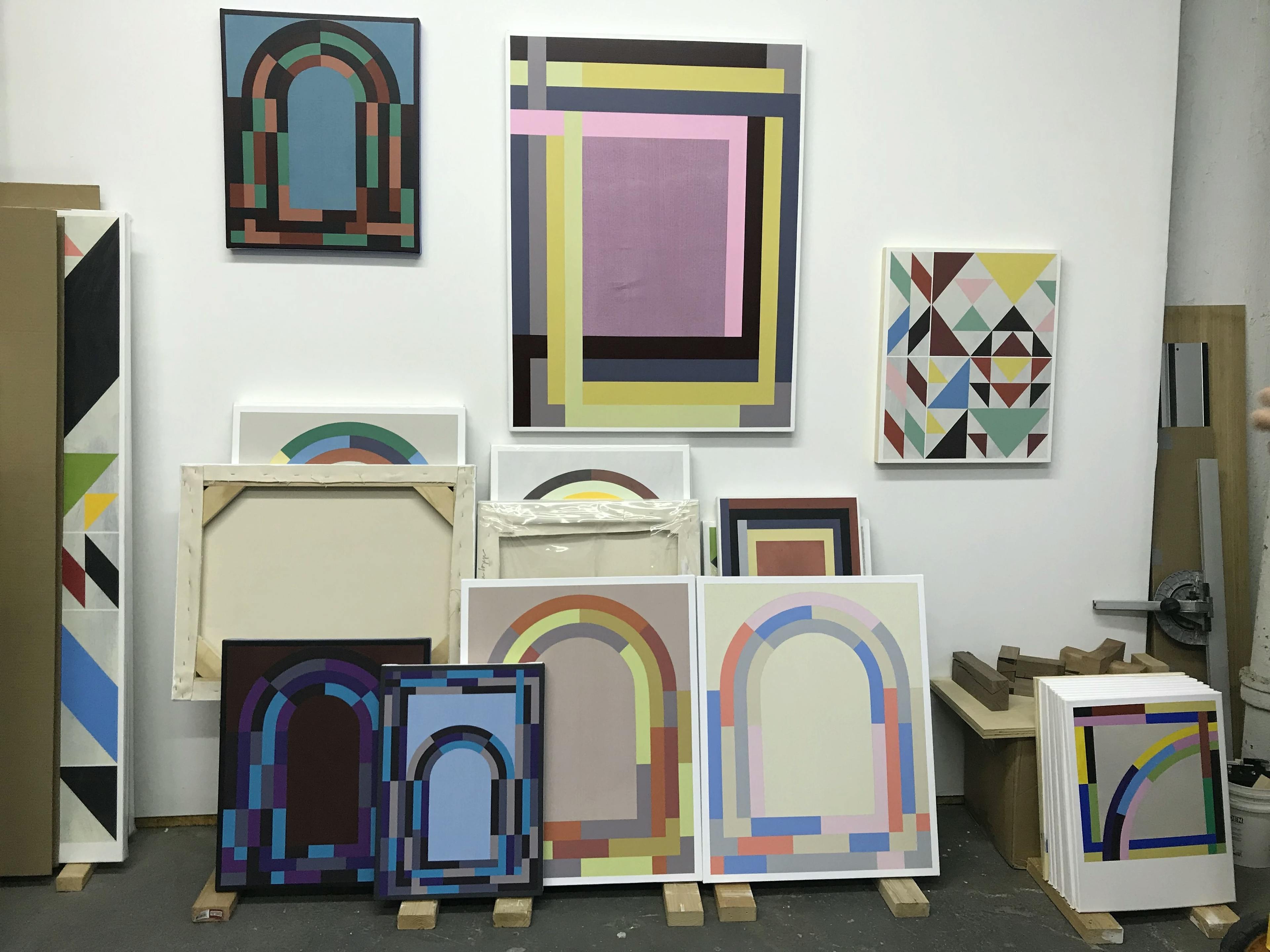 Abstract architectural paintings in artist Christian Nguyen's studio.