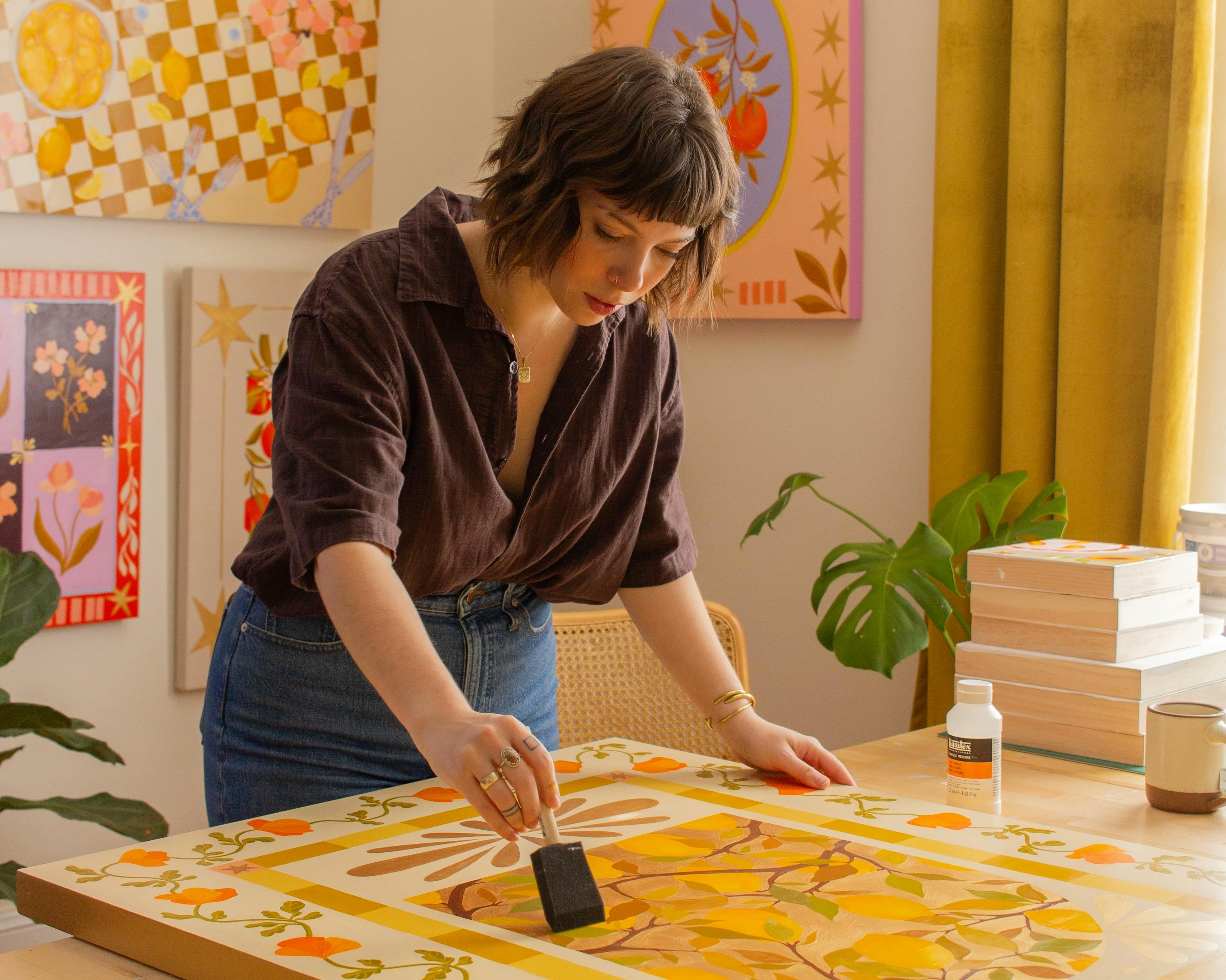 Artist Haley Elise Hughes paints in her studio.