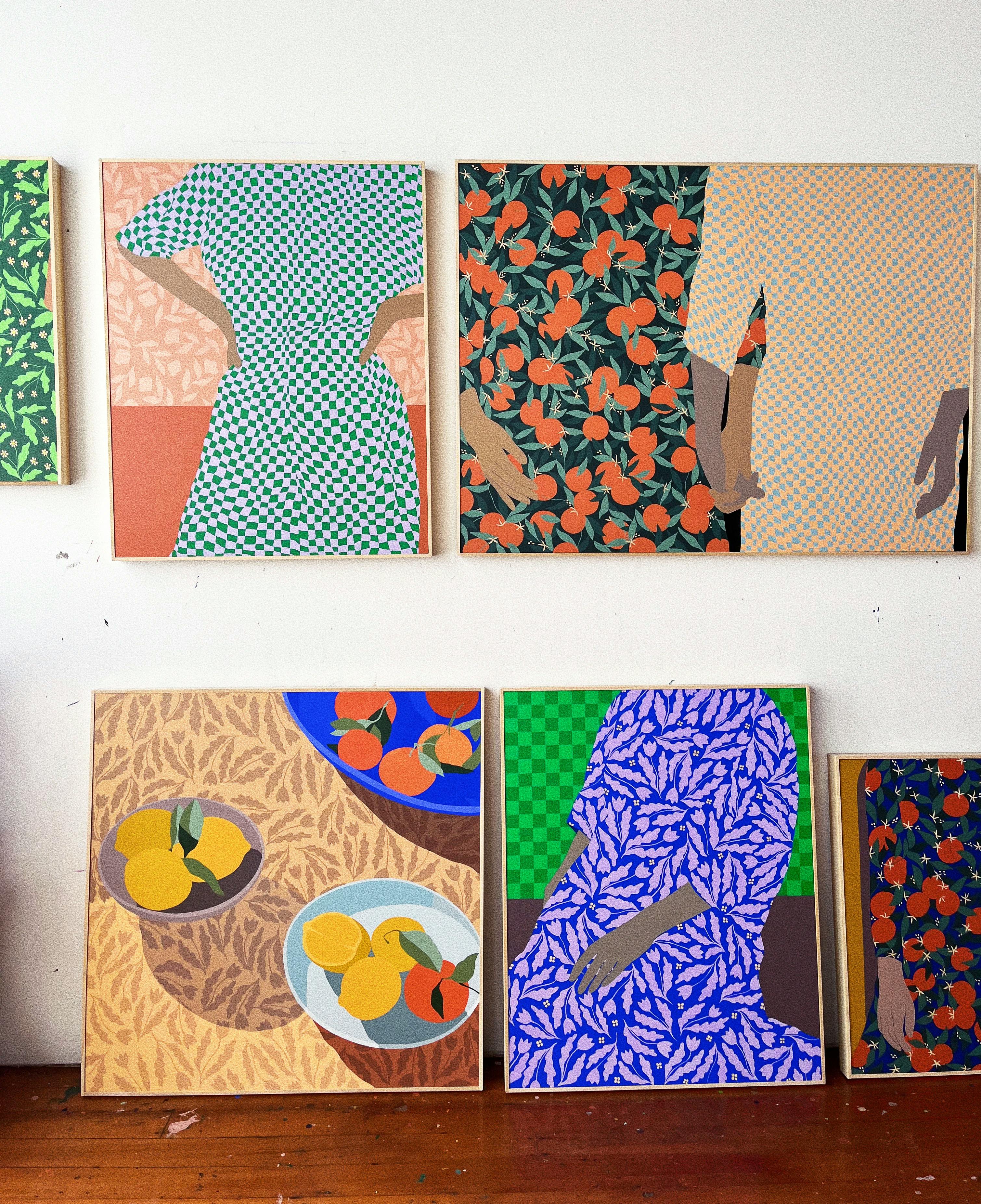 A series of bright paintings in the studio of Carmen McNall.