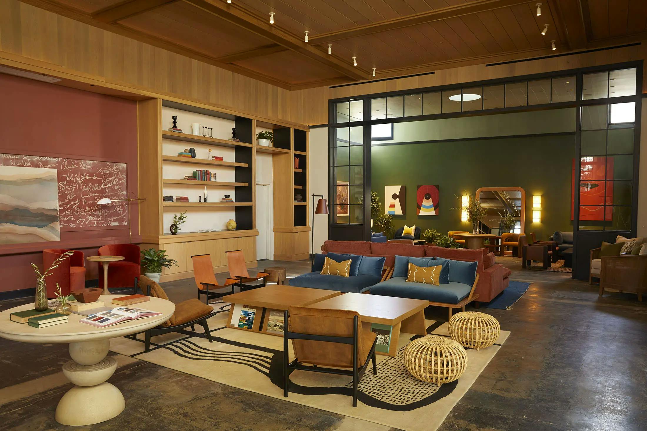 A lounge area with conversational seating and bookcases at the Chief Los Angeles Clubhouse.