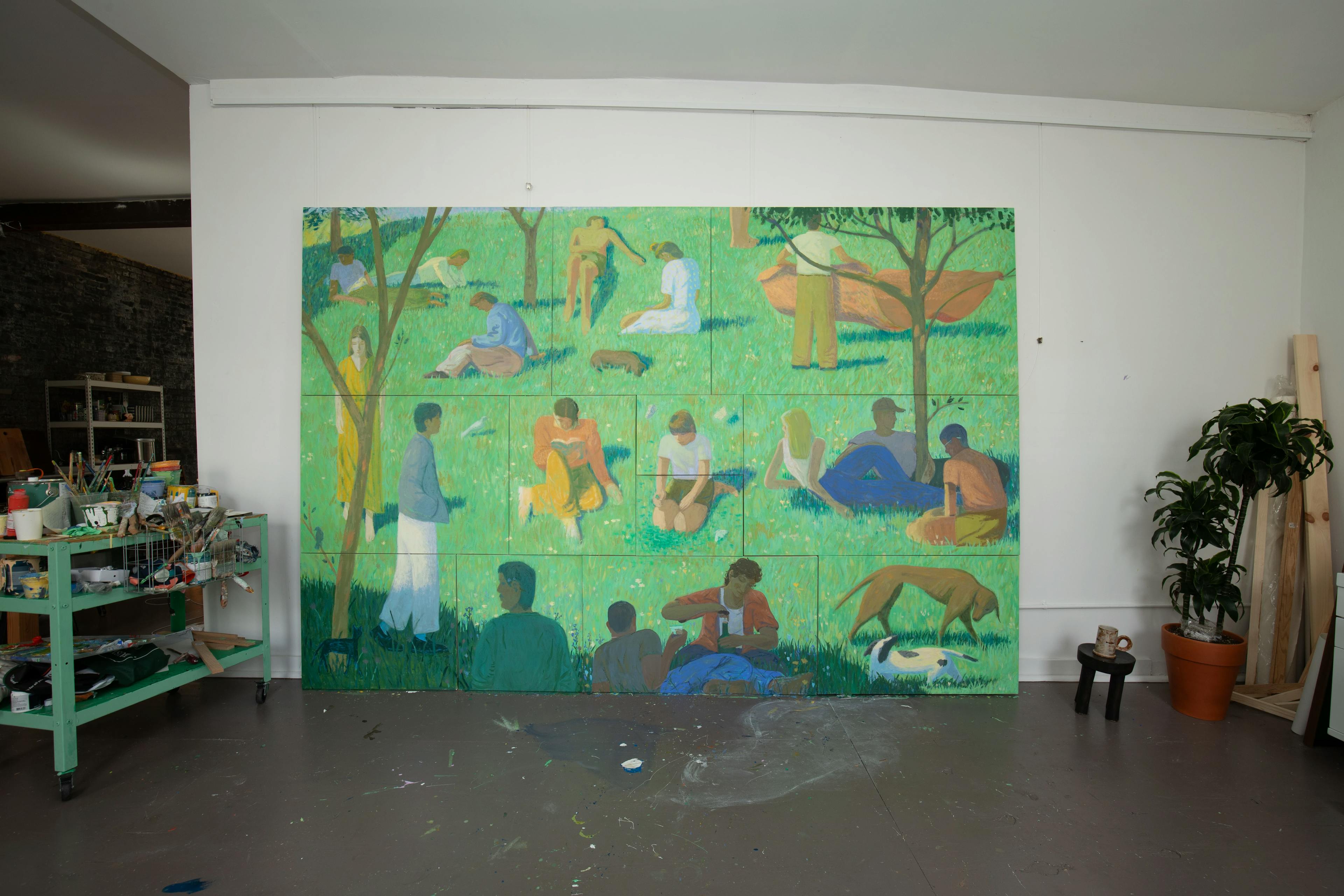 A large-scale installation comprised of individual, figurative paintings by artist Jackson Joyce, displayed against a white wall in his Brooklyn studio.