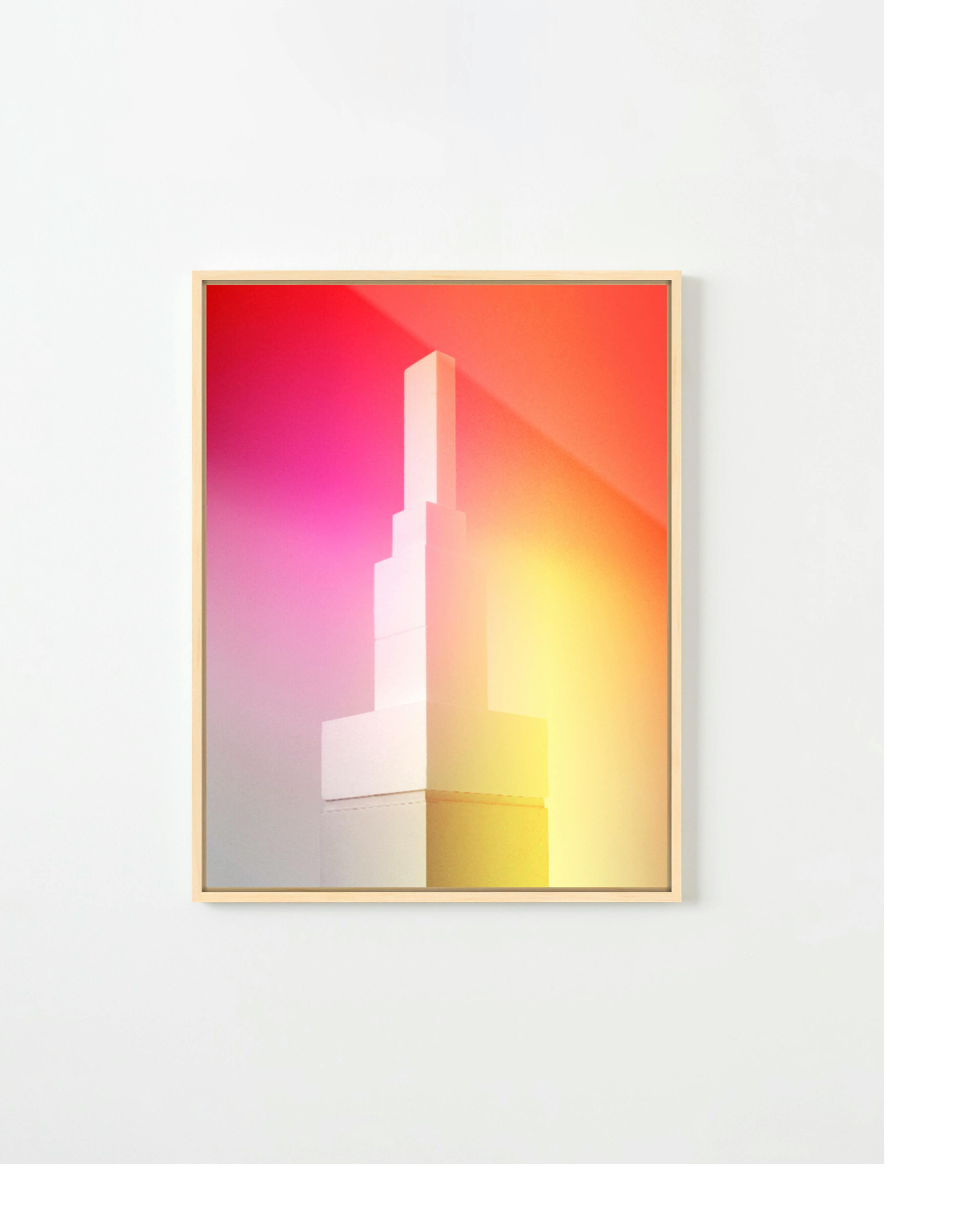 A framed print of an orange and pink gradient overlaid on a white styrofoam tower by artist Adam Ryder.