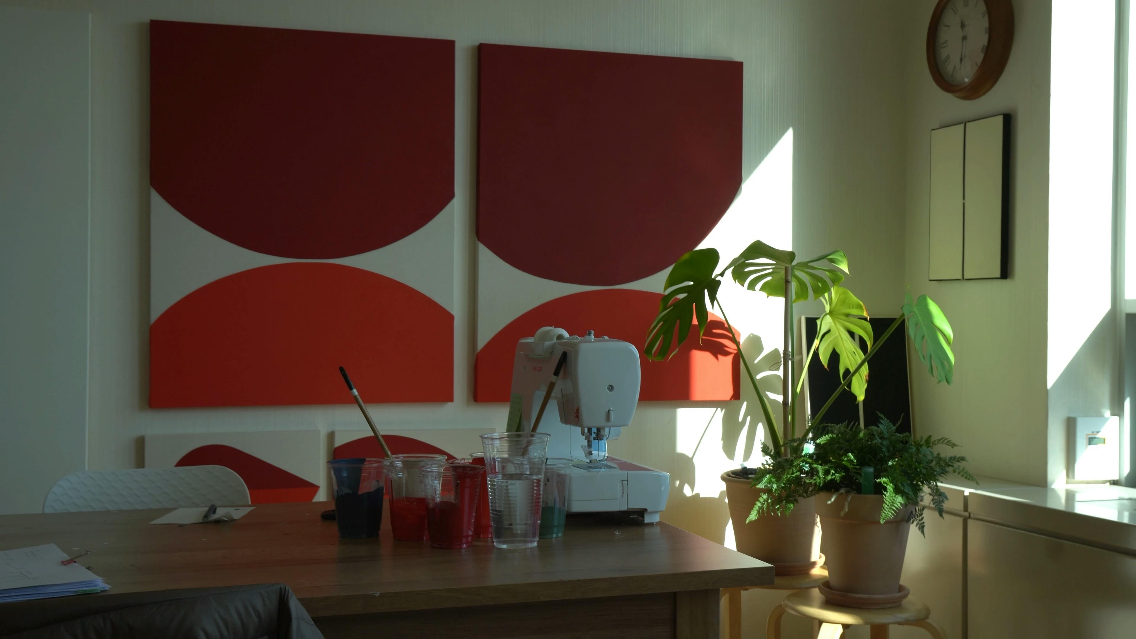 Two red paintings on canvas in Artist Hyun Jung Ahn's studio. 