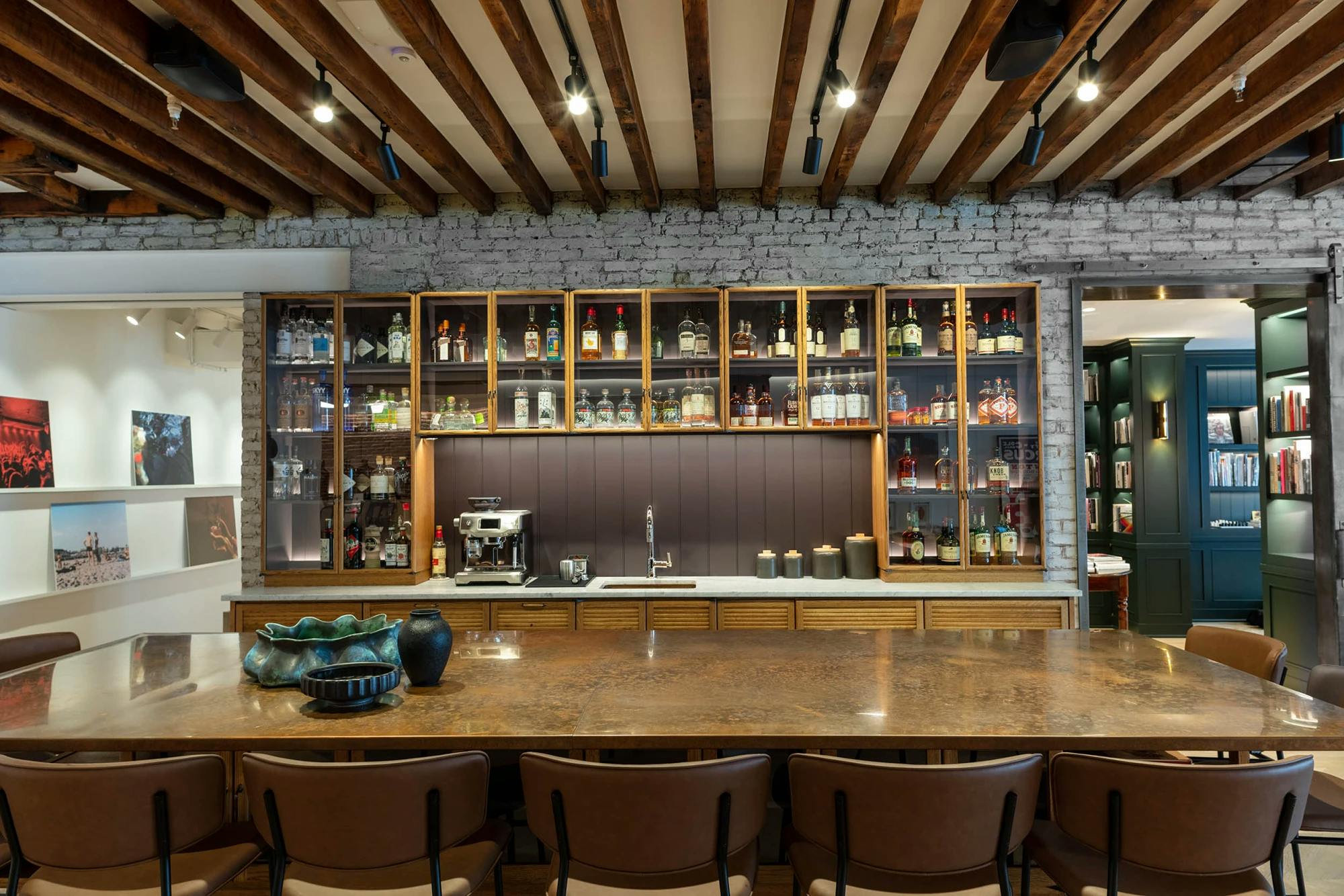 The bar area at FIG with a large central island and glass liquor cabinets.