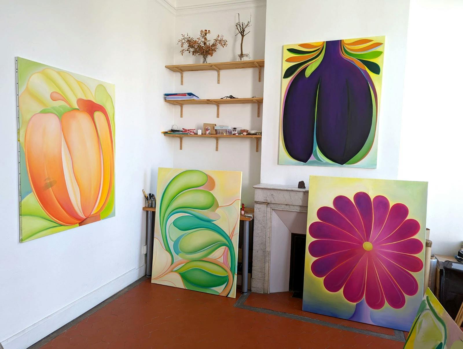 A corner of Roche's studio with four floral paintings. 
