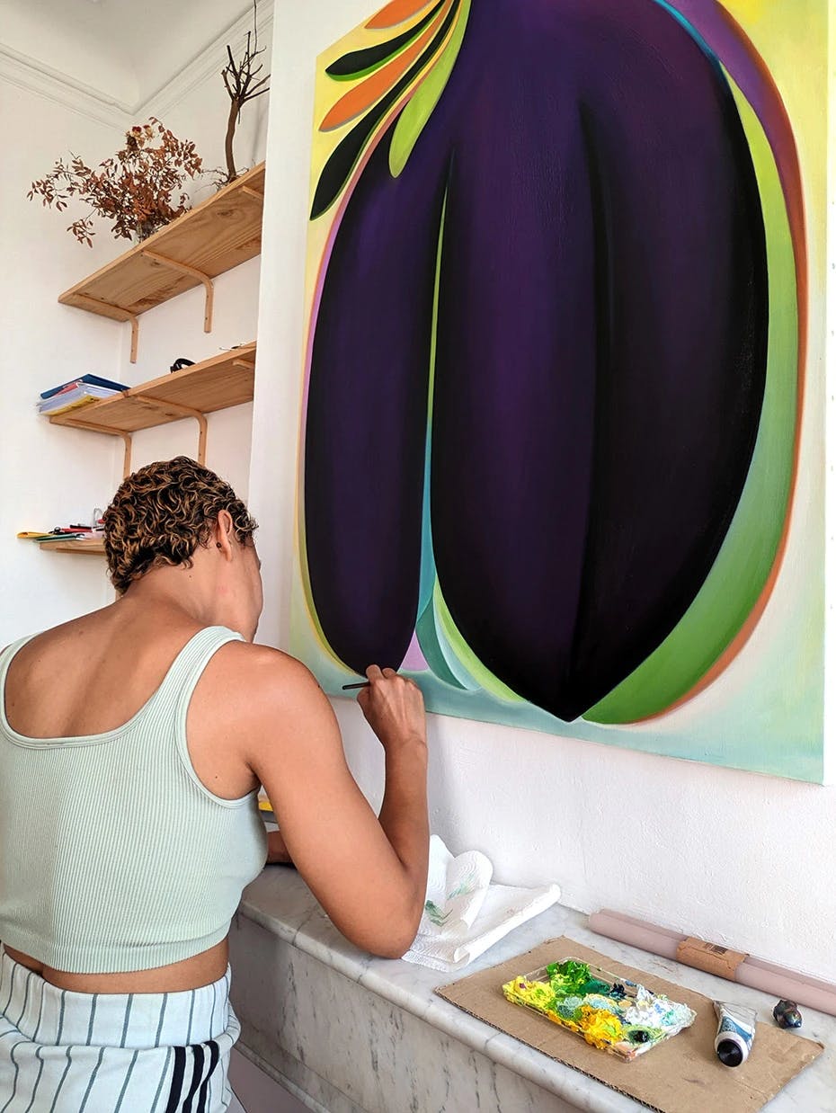 Artist Roche working on a large, abstract painting in their studio.