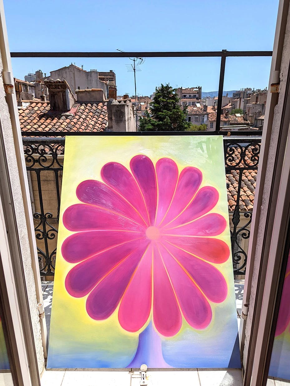 An abstract pink floral painting by Roche leaning against a balcony railing.