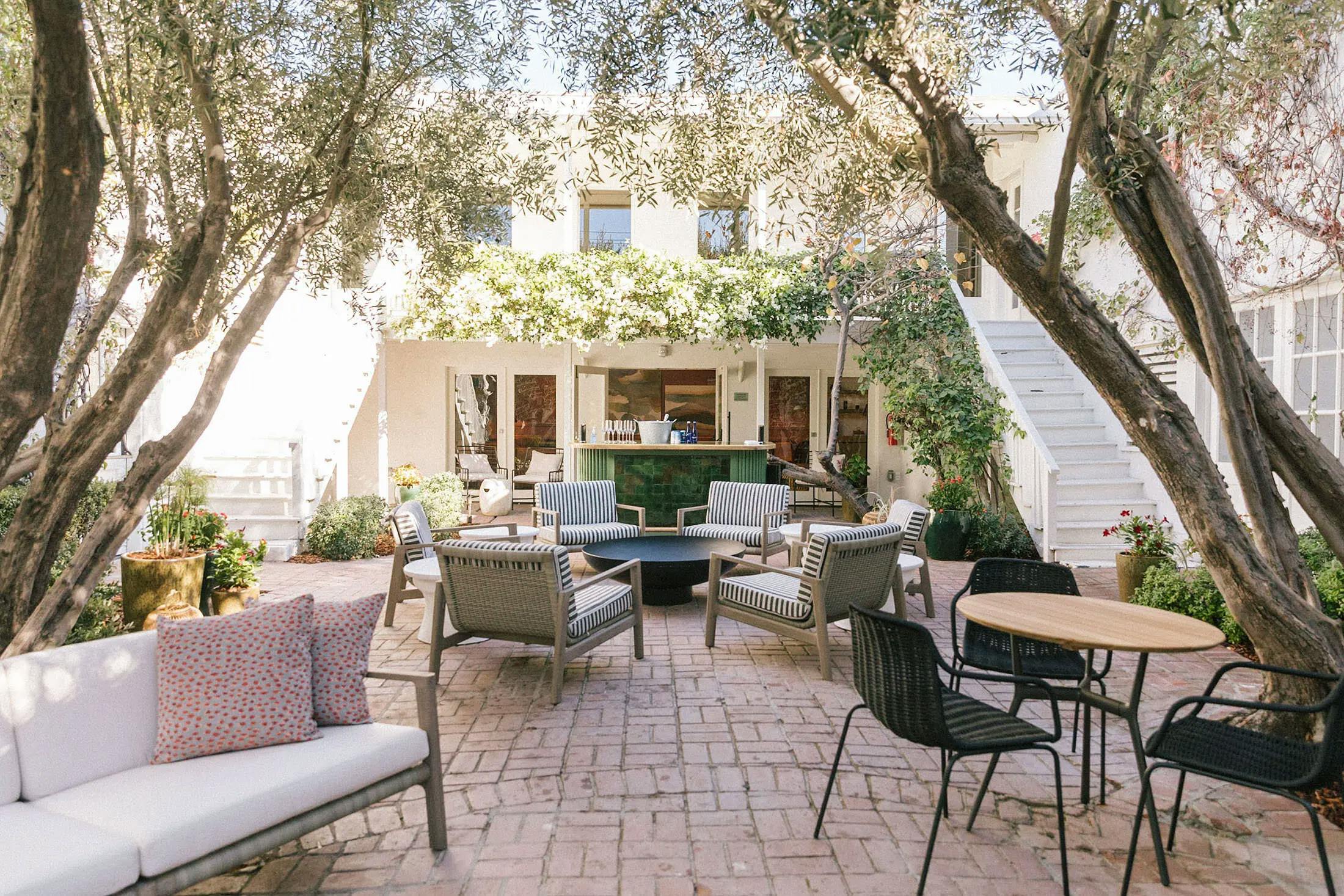 An outdoor patio with tables and chairs at the Chief Los Angeles Clubhouse.