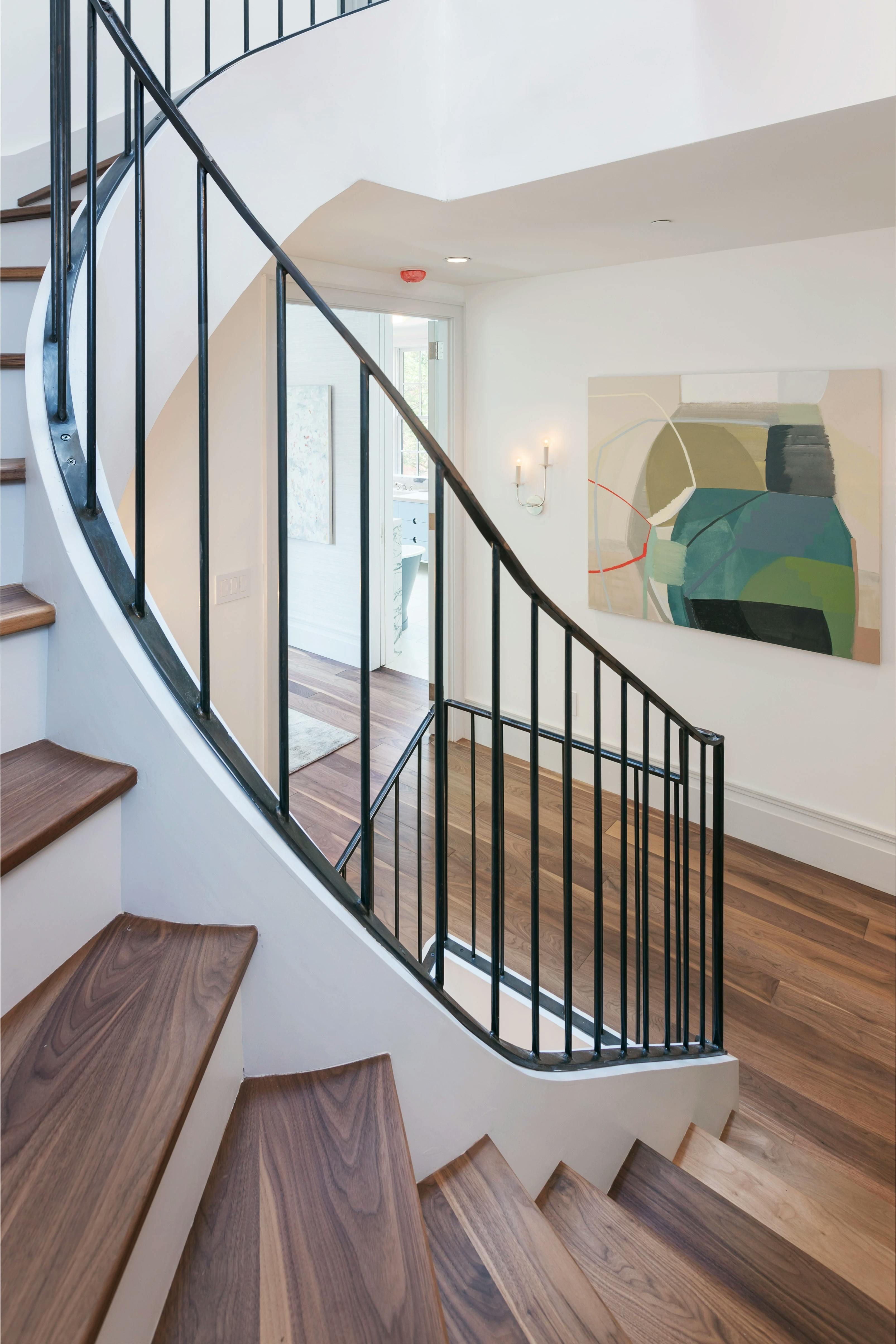 A painting by Ky Anderson installed in the landing of a staircase.