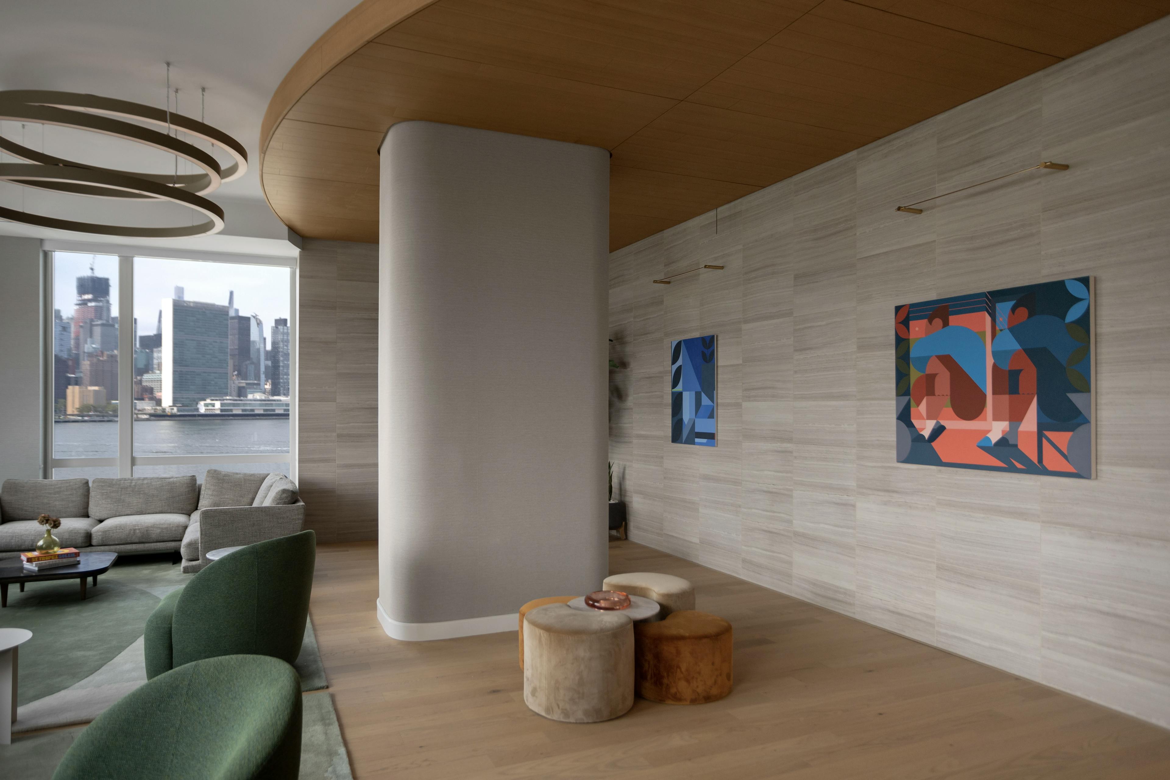 Two figurative paintings by artist Adrian Kay Wong installed on a gray wall in a residential lobby within Gotham Point.