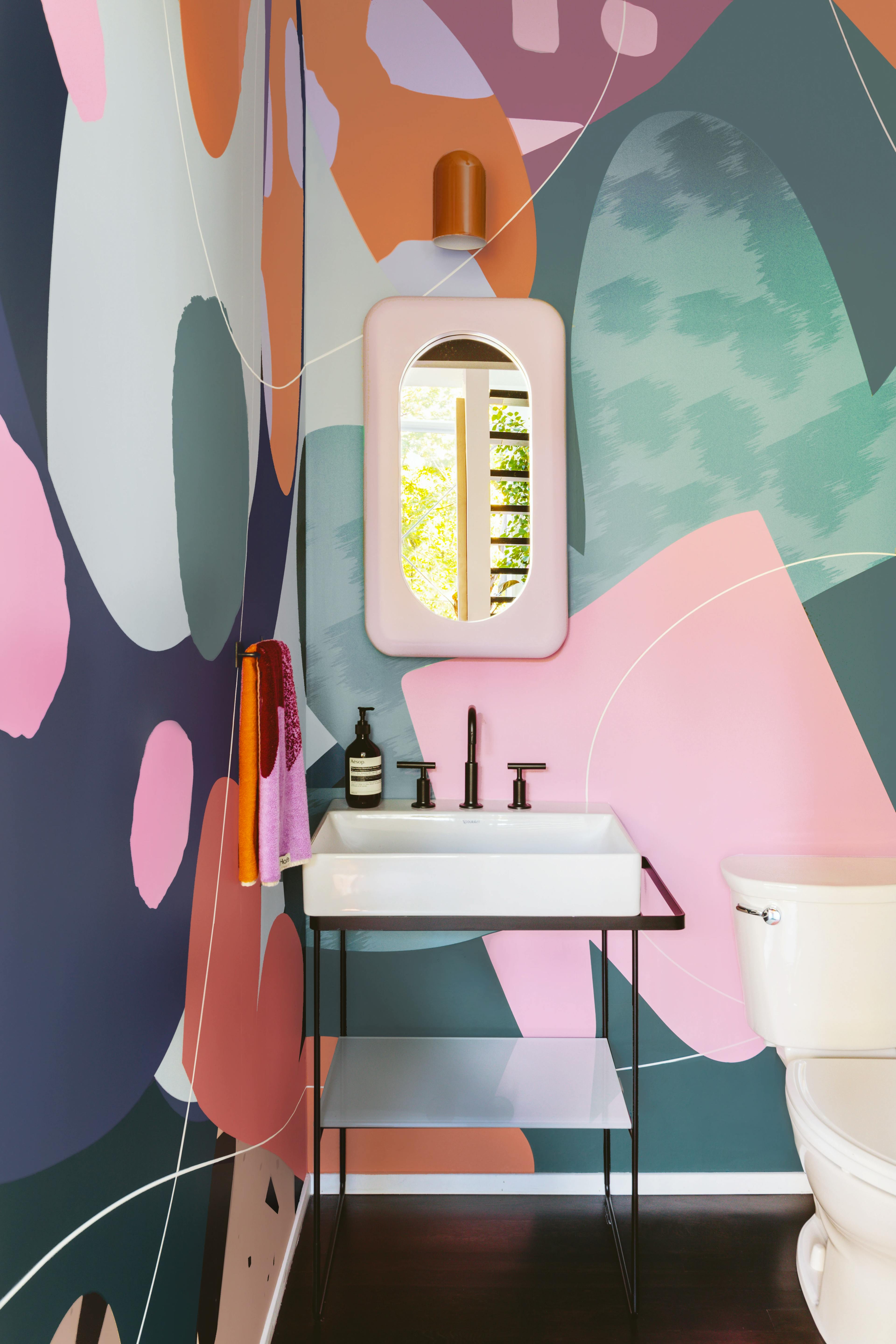 A colorful wall mural by artist Alex Proba in her bathroom. 