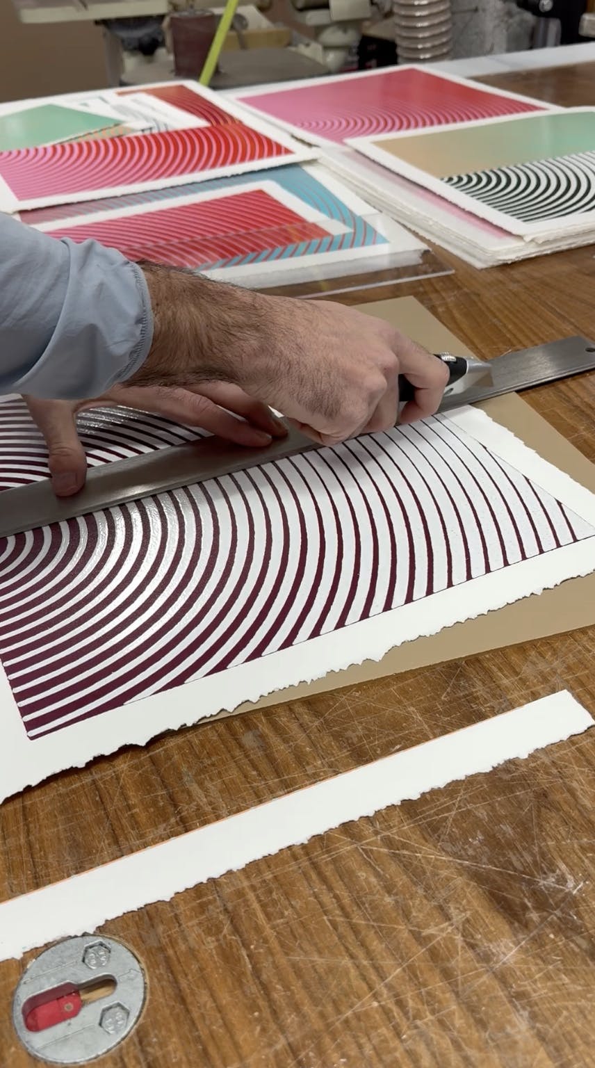 Artist Matt Neuman cutting straight lines on his geometric prints.