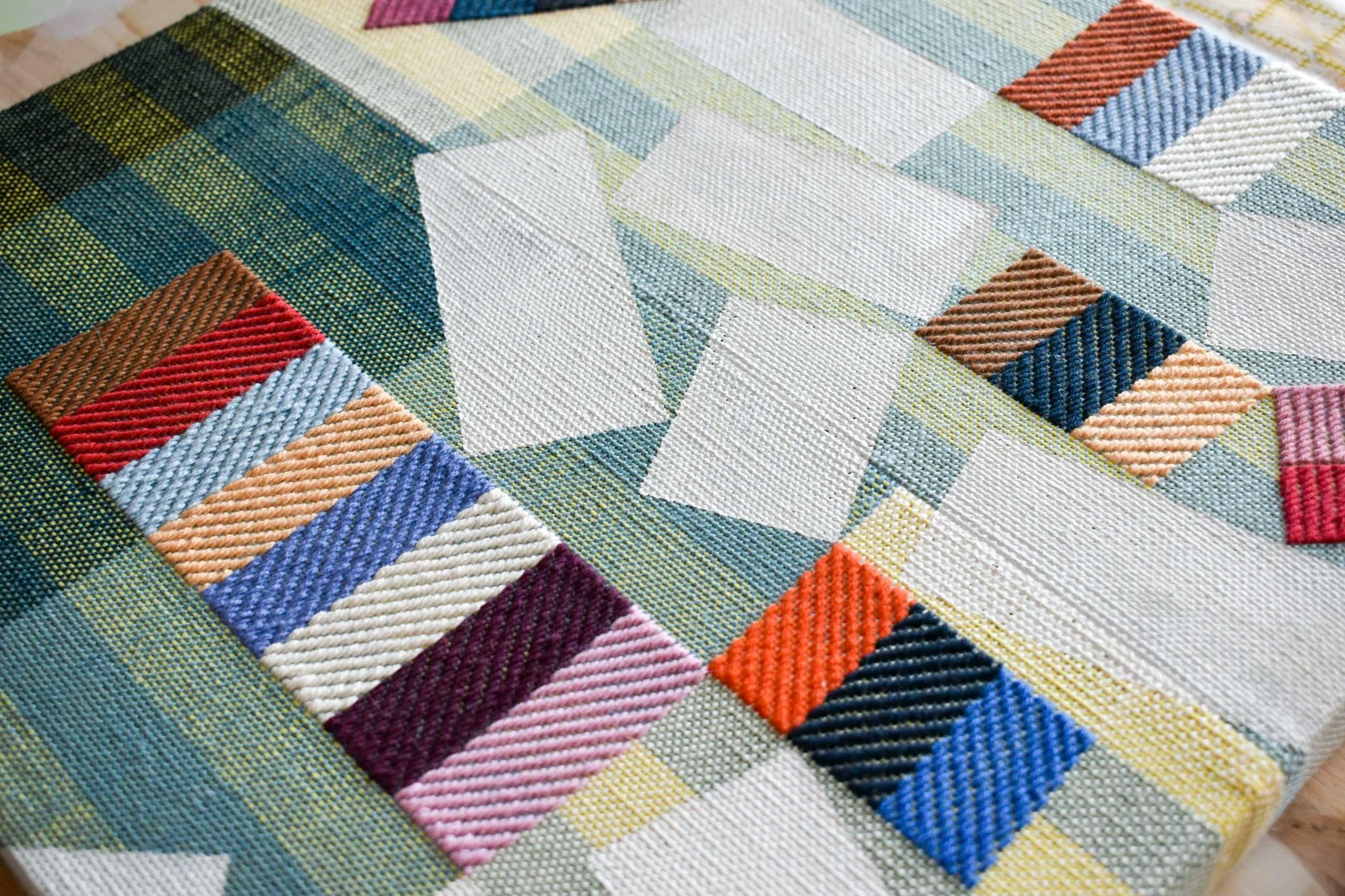 A close-up of handwoven striped patches on canvas by artist Sarah Sullivan Sherrod.