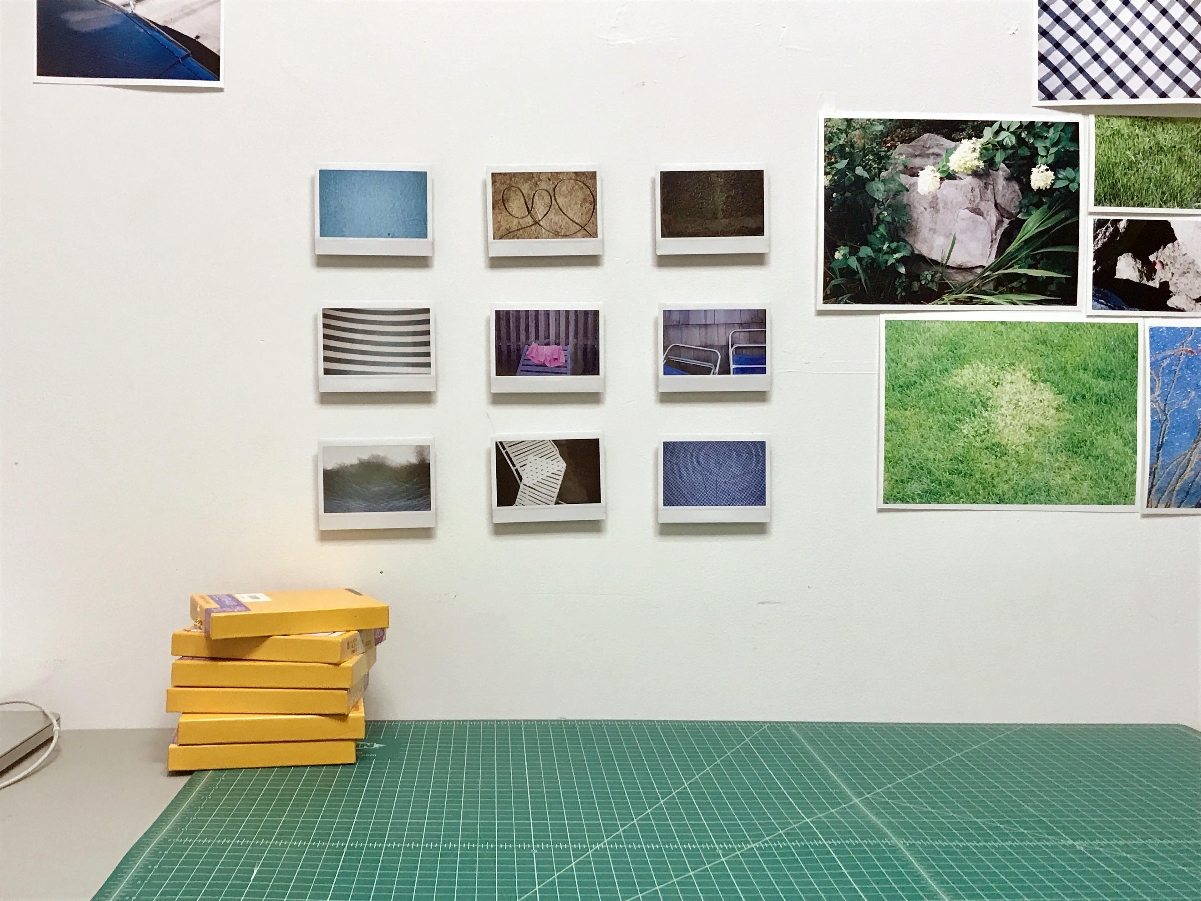 A stack of polaroids and images by artist Ryan James MacFarland pinned up on a wall in his studio.