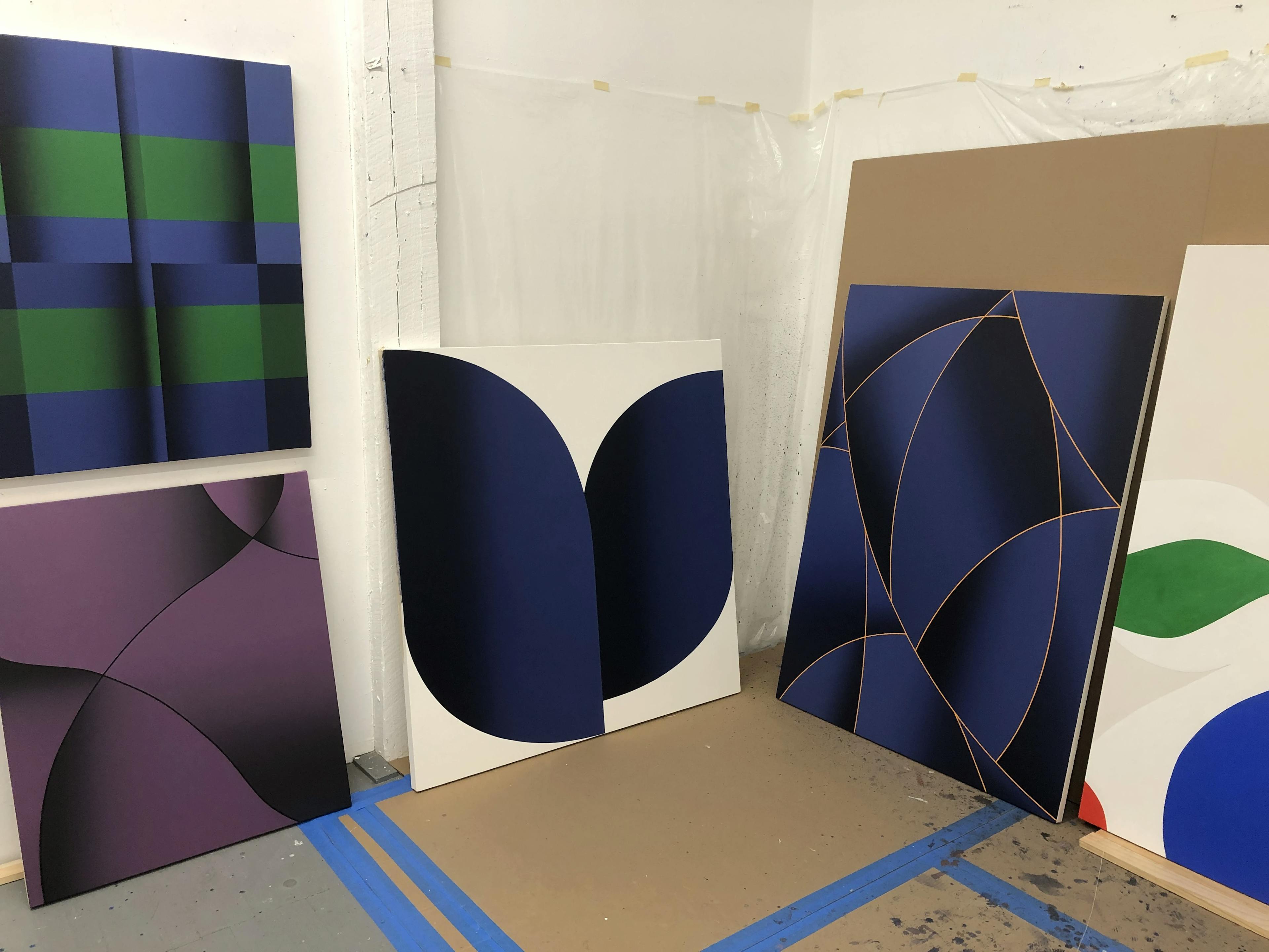 Five abstract geometric paintings by artist Senem Oezdogan inside her Brooklyn studio.