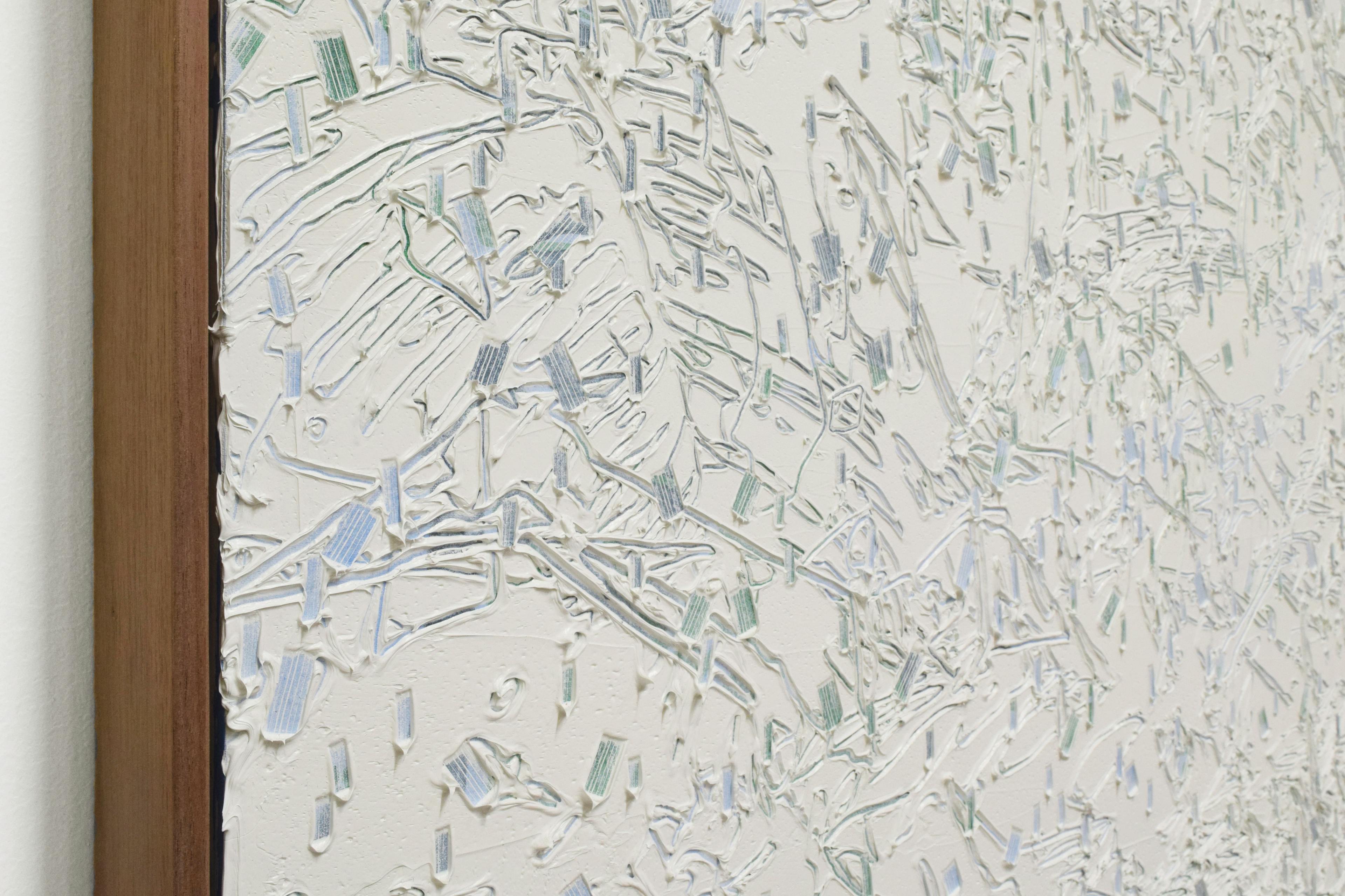 A close-up of a textured work by artist Blake Aaseby with blue and green lines carved into thick layers of gray paint.