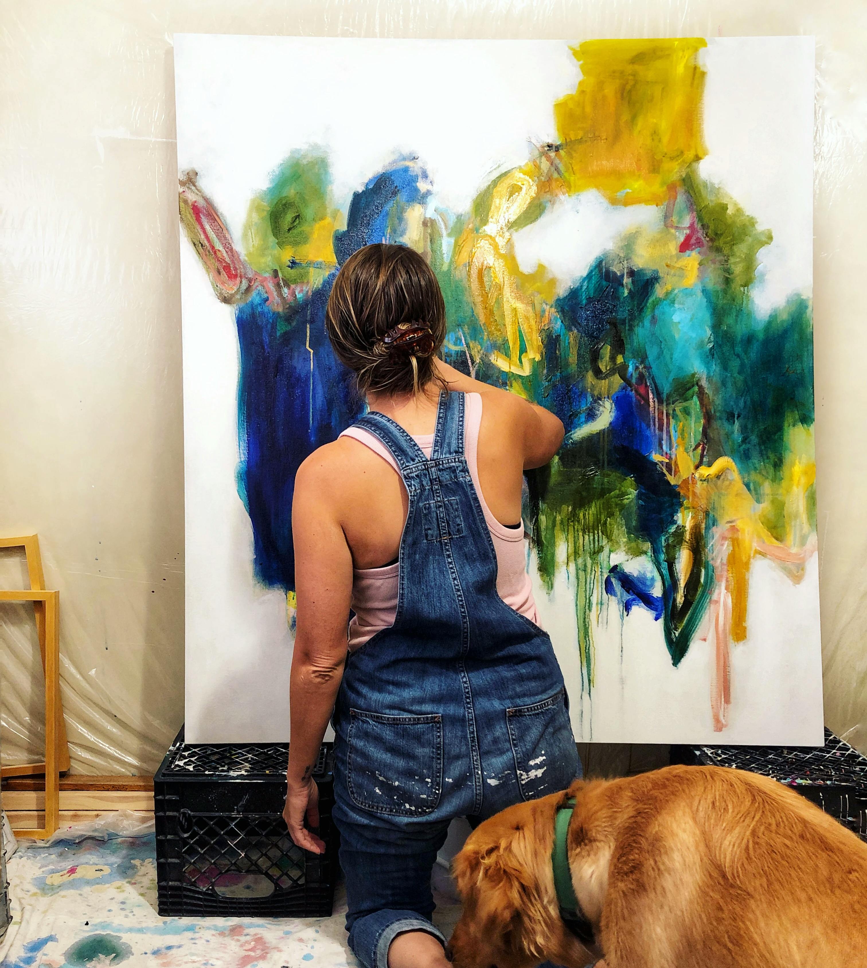 Artist Elisa Gomez and dog in studio.