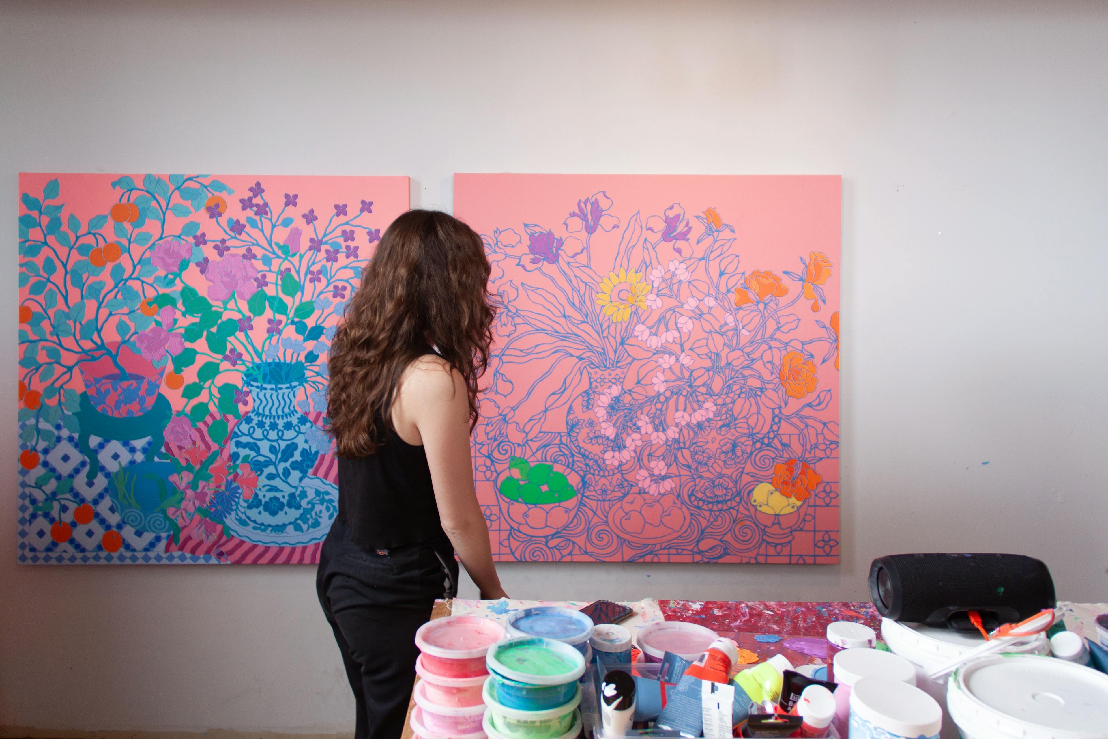 Sarah Ingraham standing in front of a large in-progress painting. 